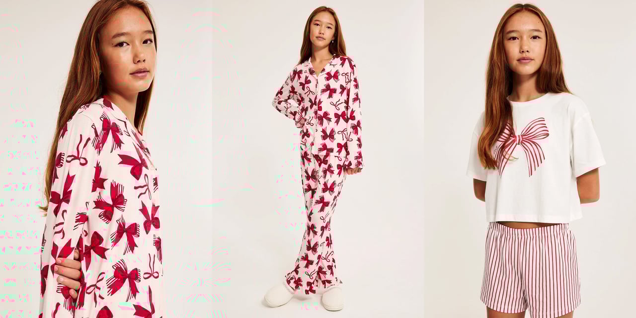 Tyttö vaaleanpunaisissa kuviollisissa mustissa pyjamissa.