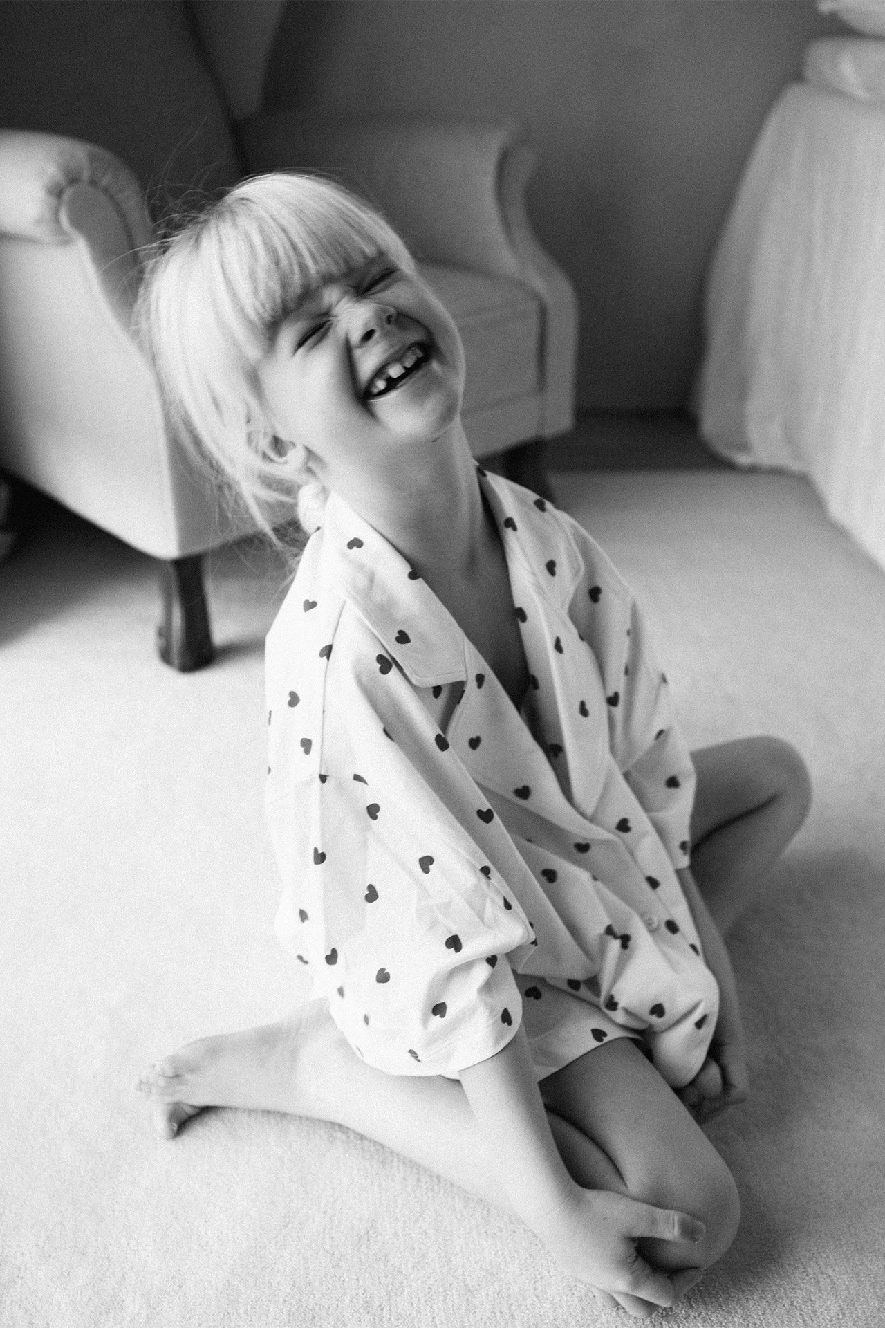 Tyttö pyjamassa, jossa on sydämet.