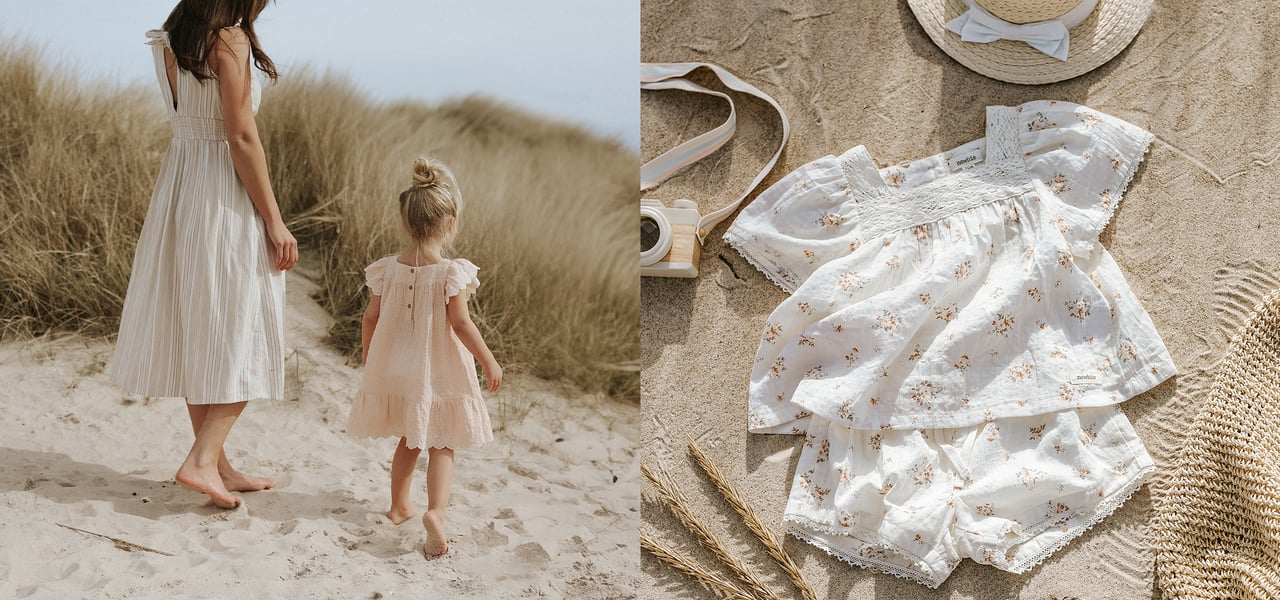 blommiga matchande kläder för barn och mamma visas på en strand