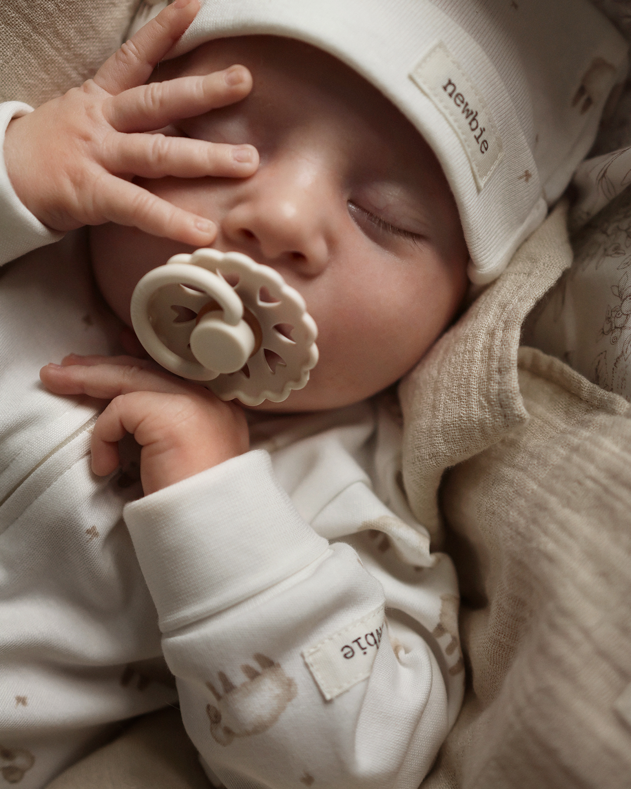 Baby i klær fra Newbie's kolleksjon mykt og koselig, lite lam.
