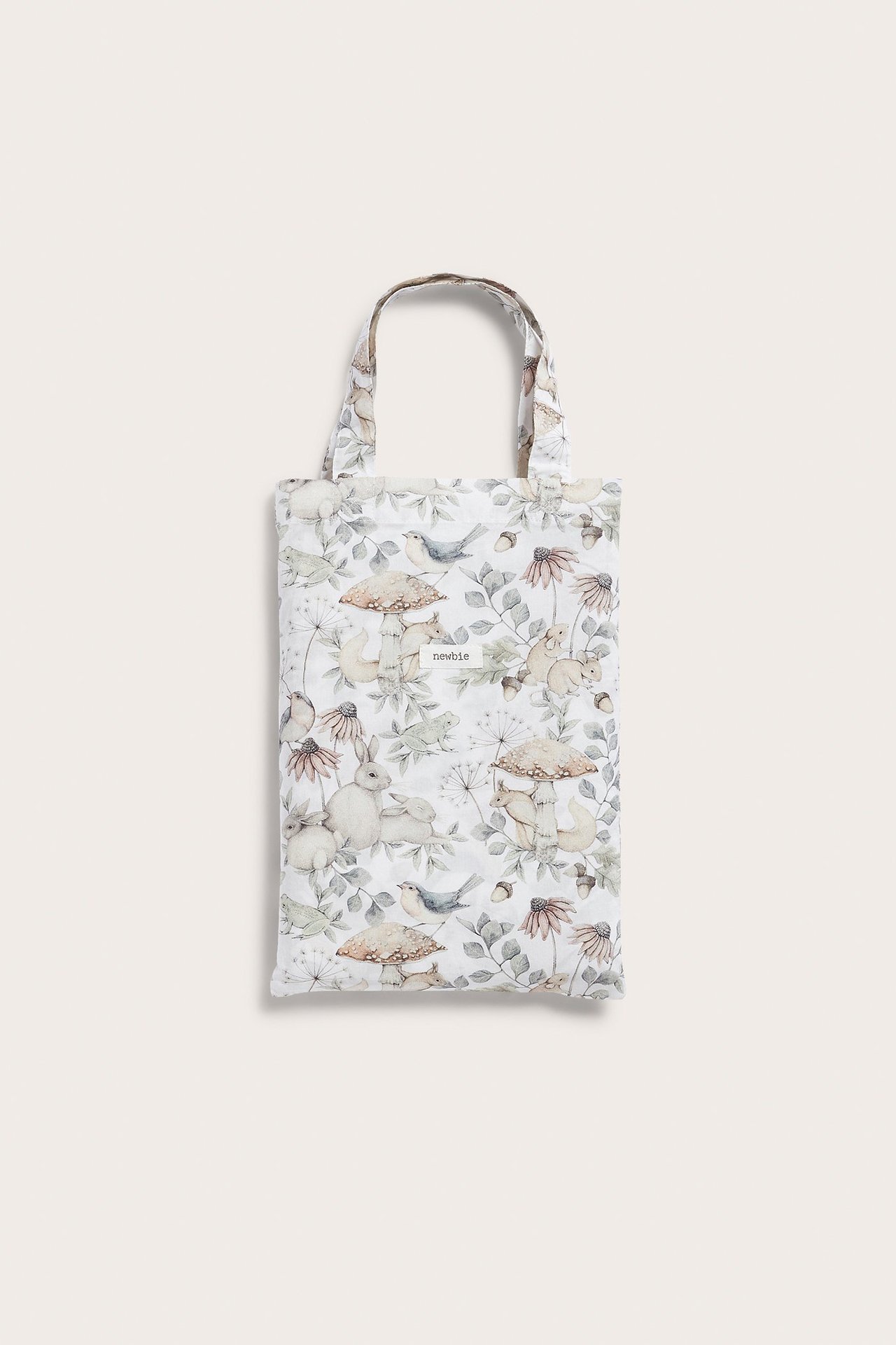 Widok z przodu beżowego bawełnianego kompletu pościeli z leśnym wzorem, złożonego.