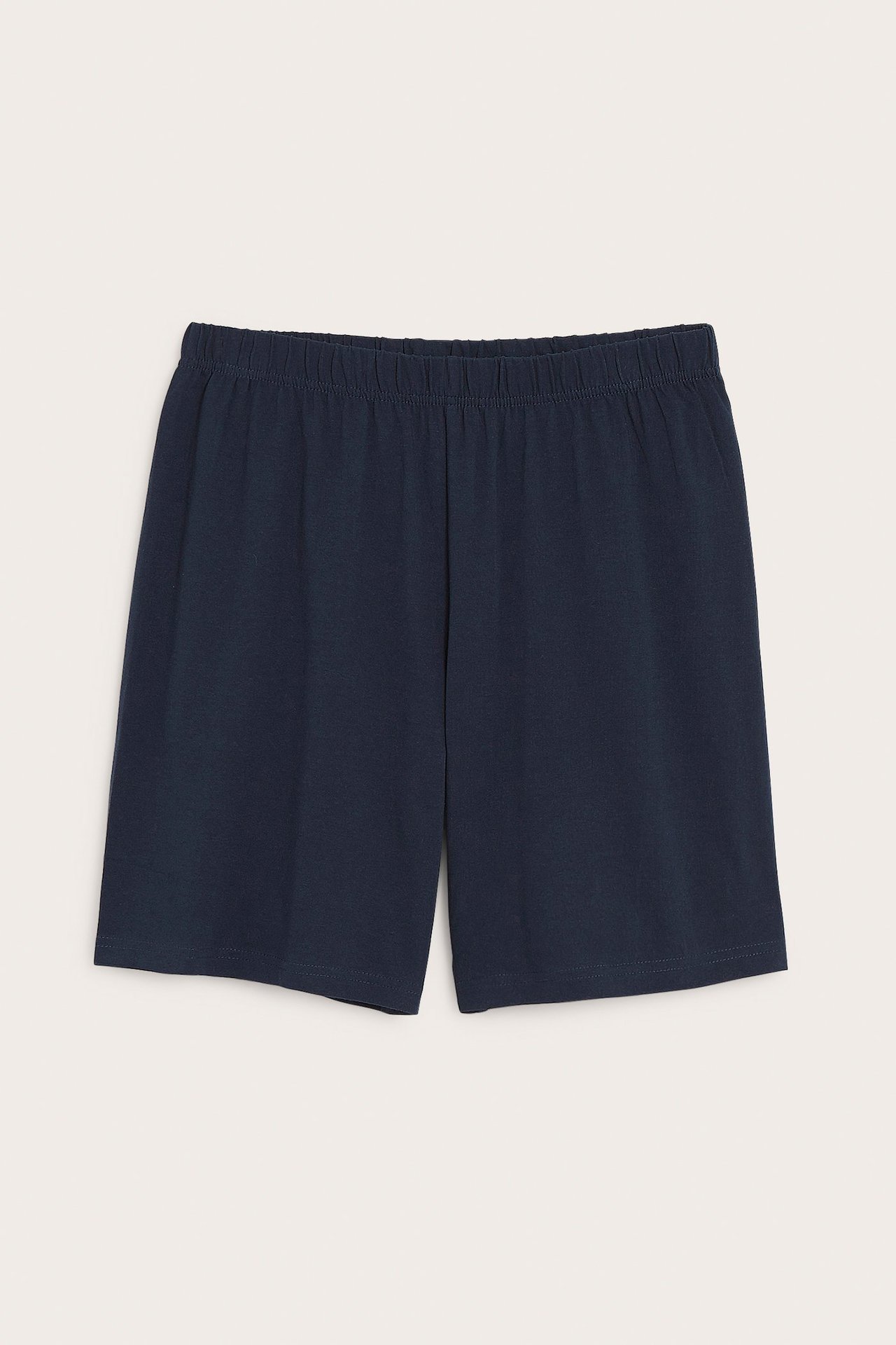 Framifrån, mörkblå enfärgade pyjamasshorts i jersey med dold resår.