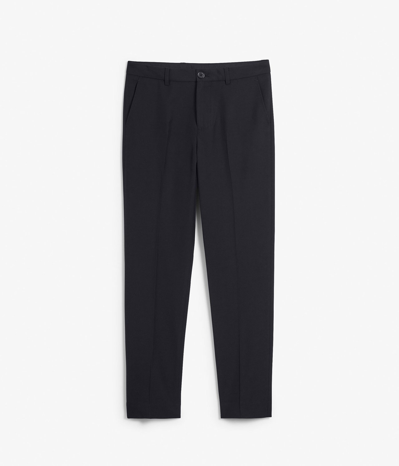 Edestä näkymä tummansinisistä yksivärisistä pukuhousuista nappi- ja vetoketjukiinnityksellä.