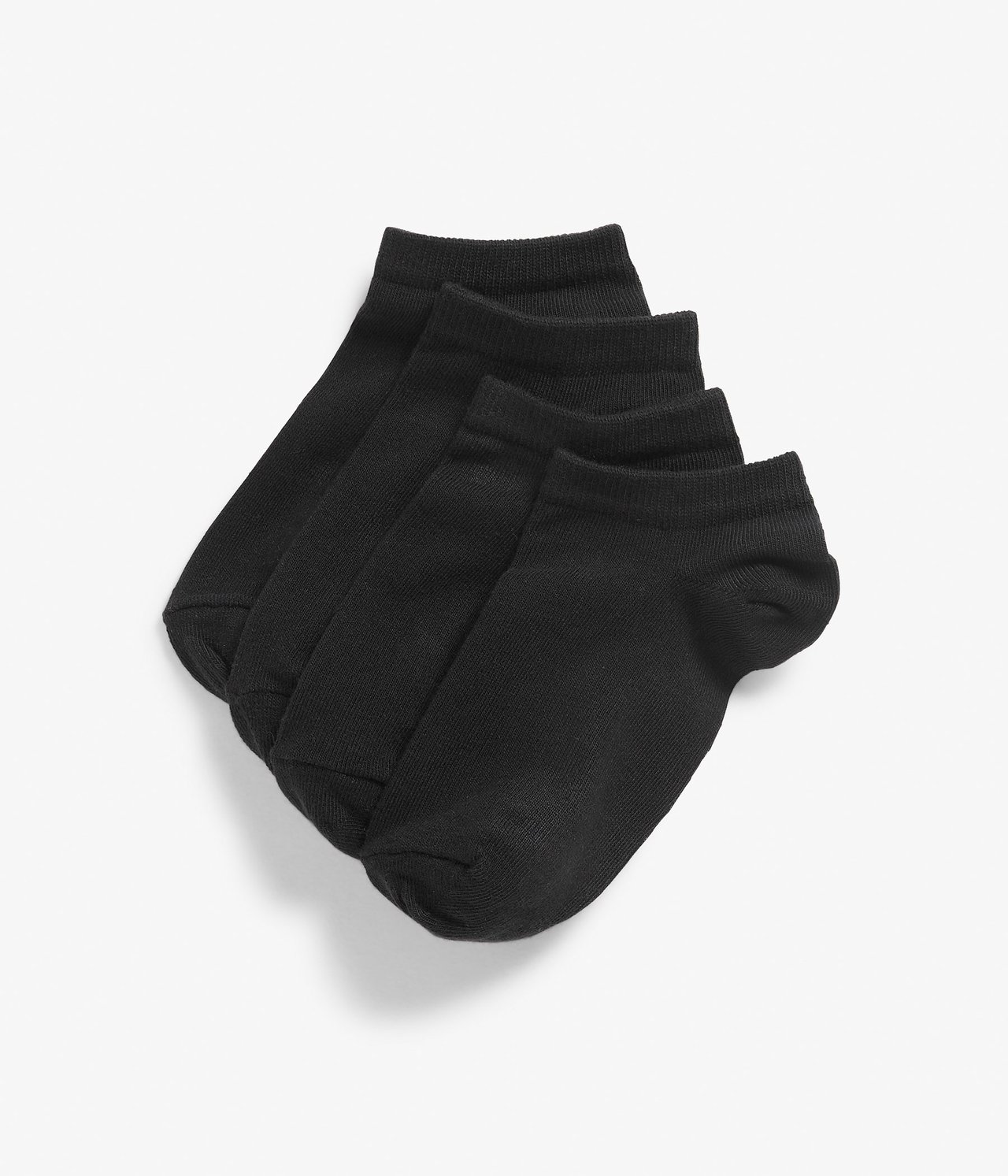 Widok z góry: Cztery pary jednolitych czarnych skarpetek, ułożone w stos i rozłożone.