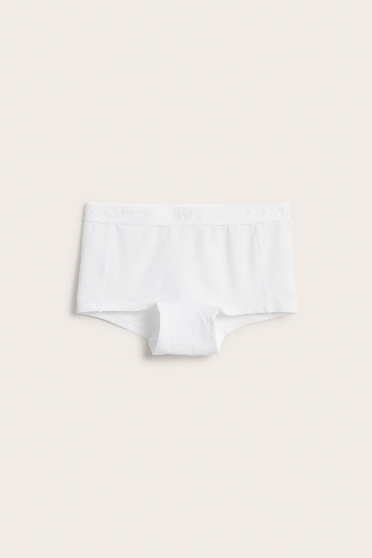 Edestä näkymä lasten valkoisista luomupuuvillaisista bokserialushousuista, joissa on leveä kuminauhavyötärö.