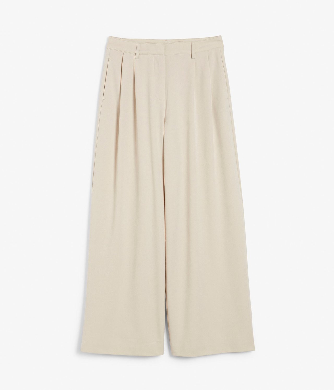 Forfra, lysebeige vide bukser med legg foran.