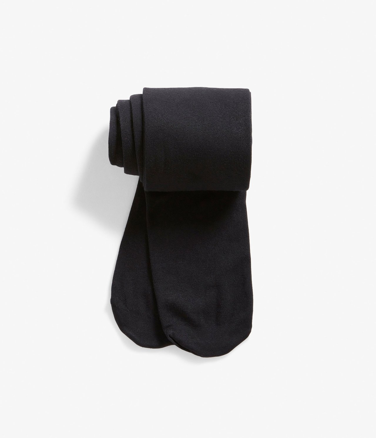 Ylhäältä kuvattu, taitetut mustat läpinäkymättömät sukkahousut.