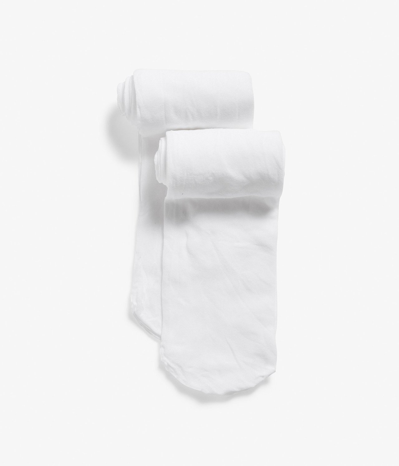 Widok z góry na dwie pary białych rajstop, starannie zwiniętych.
