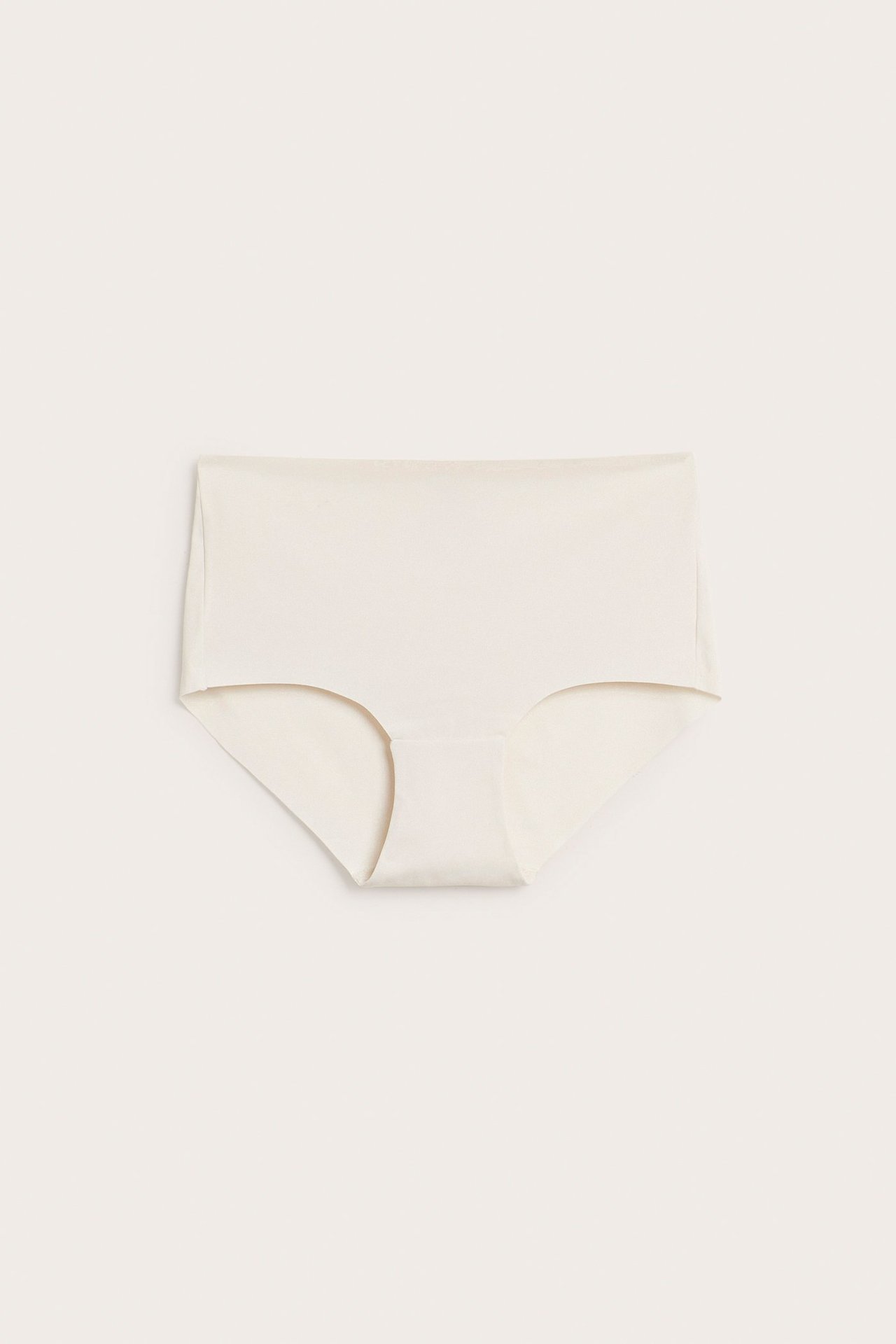 Framifrån, enfärgad beige cleancut hipstertrosa för dam i mjuk mikrokvalitet.