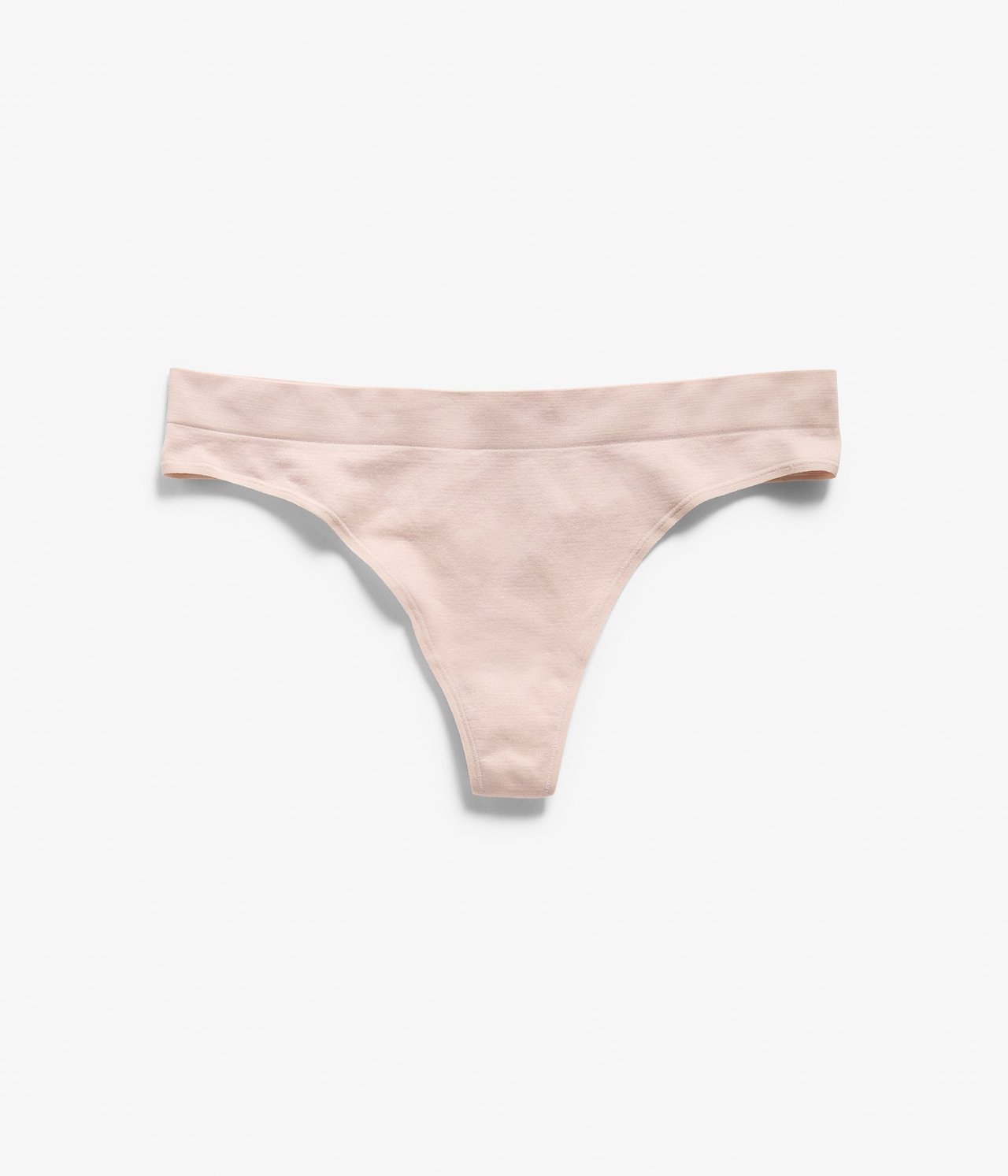 Forfra, en lys rosa sømløs stringtruse i polyamid.