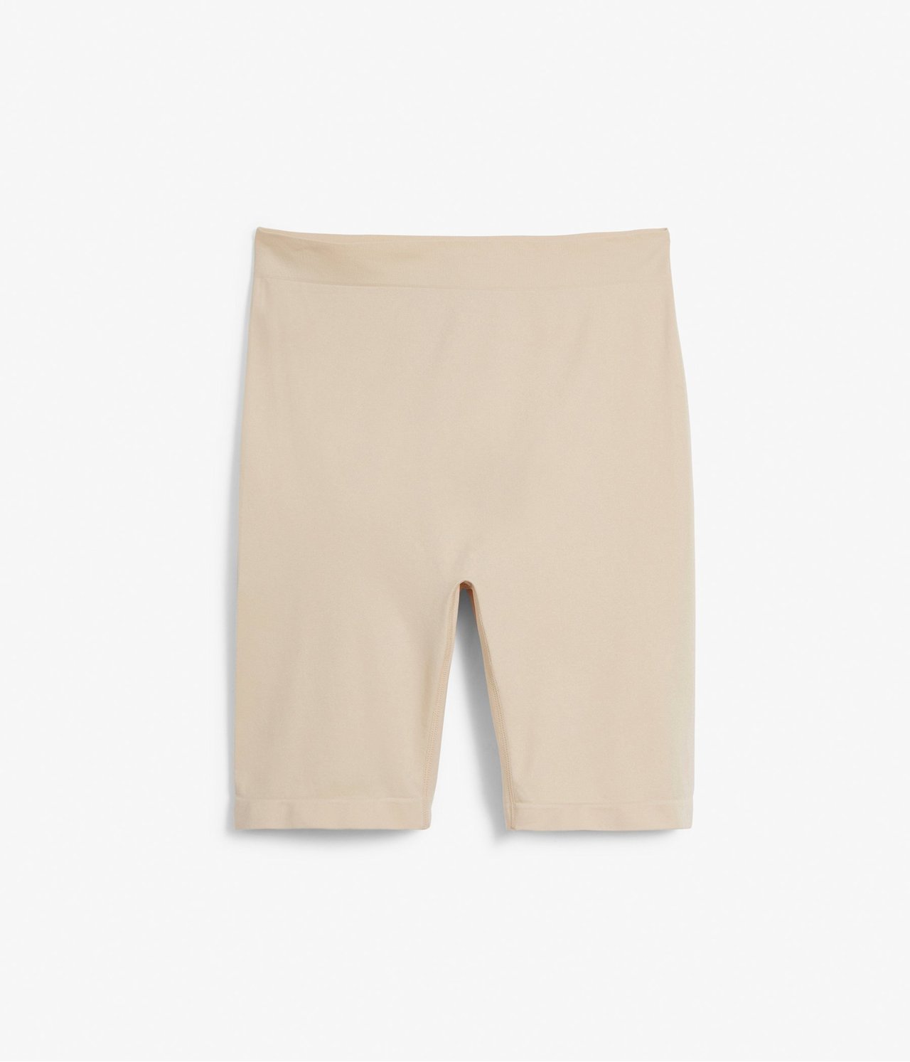 Frontvisning av beige sømløse shorts laget av en elastisk polyamidblanding.