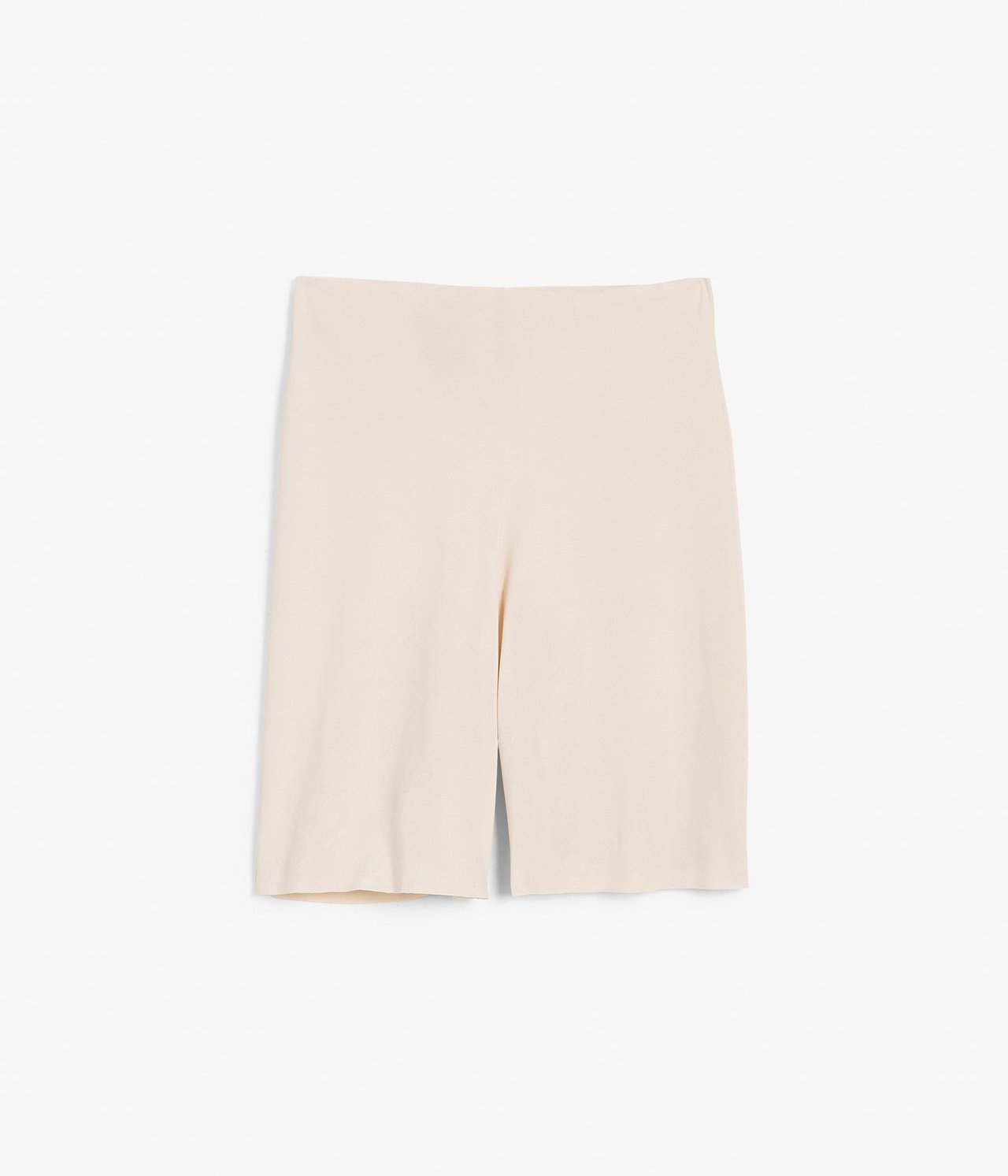 Frontvisning av beige sømløse shorts i mykt, ensfarget mikromateriale, flatlagt.