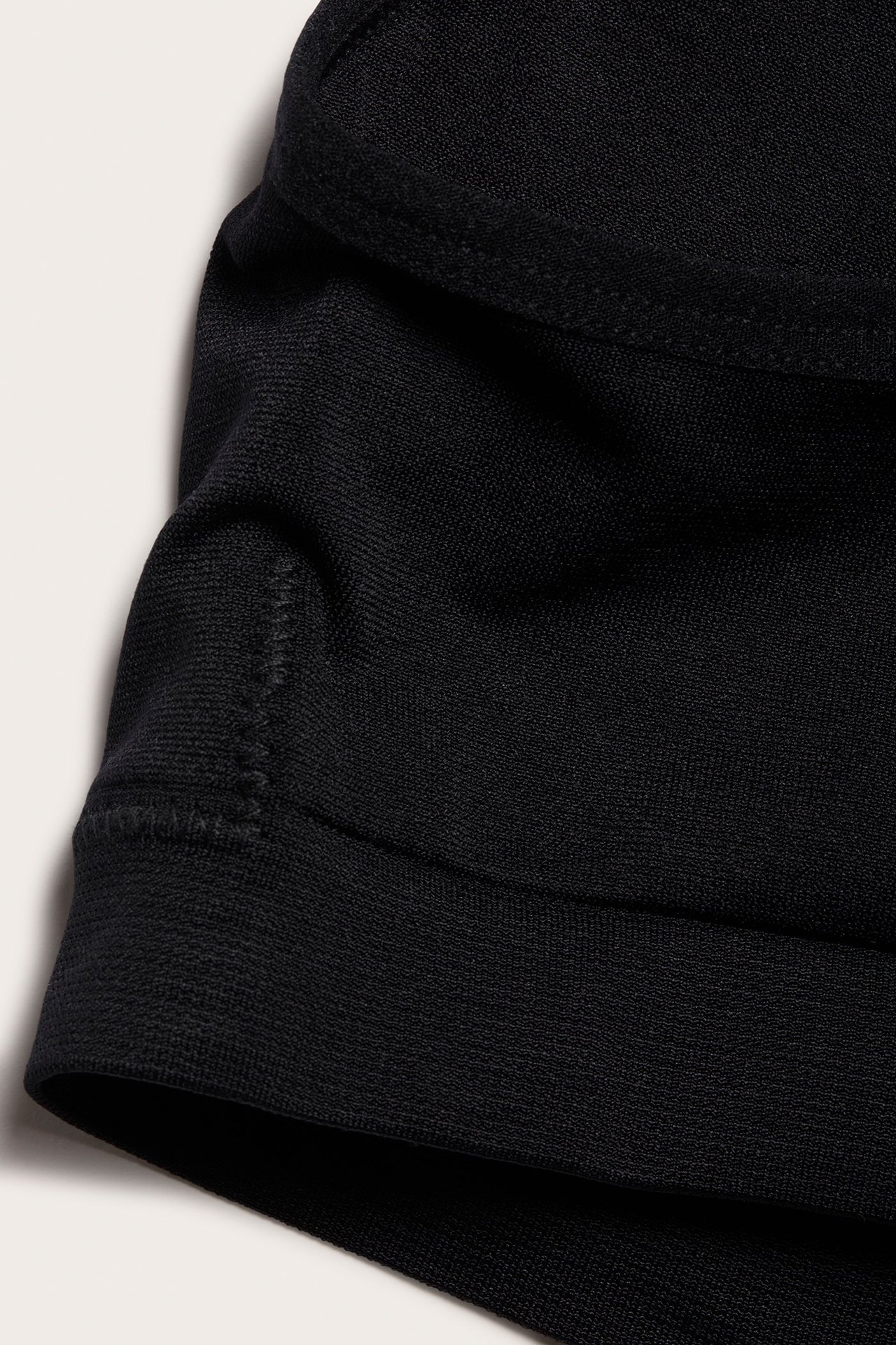 Zbliżenie czarnego bezszwowego biustonosza, ukazujące miękki materiał i subtelne szwy.