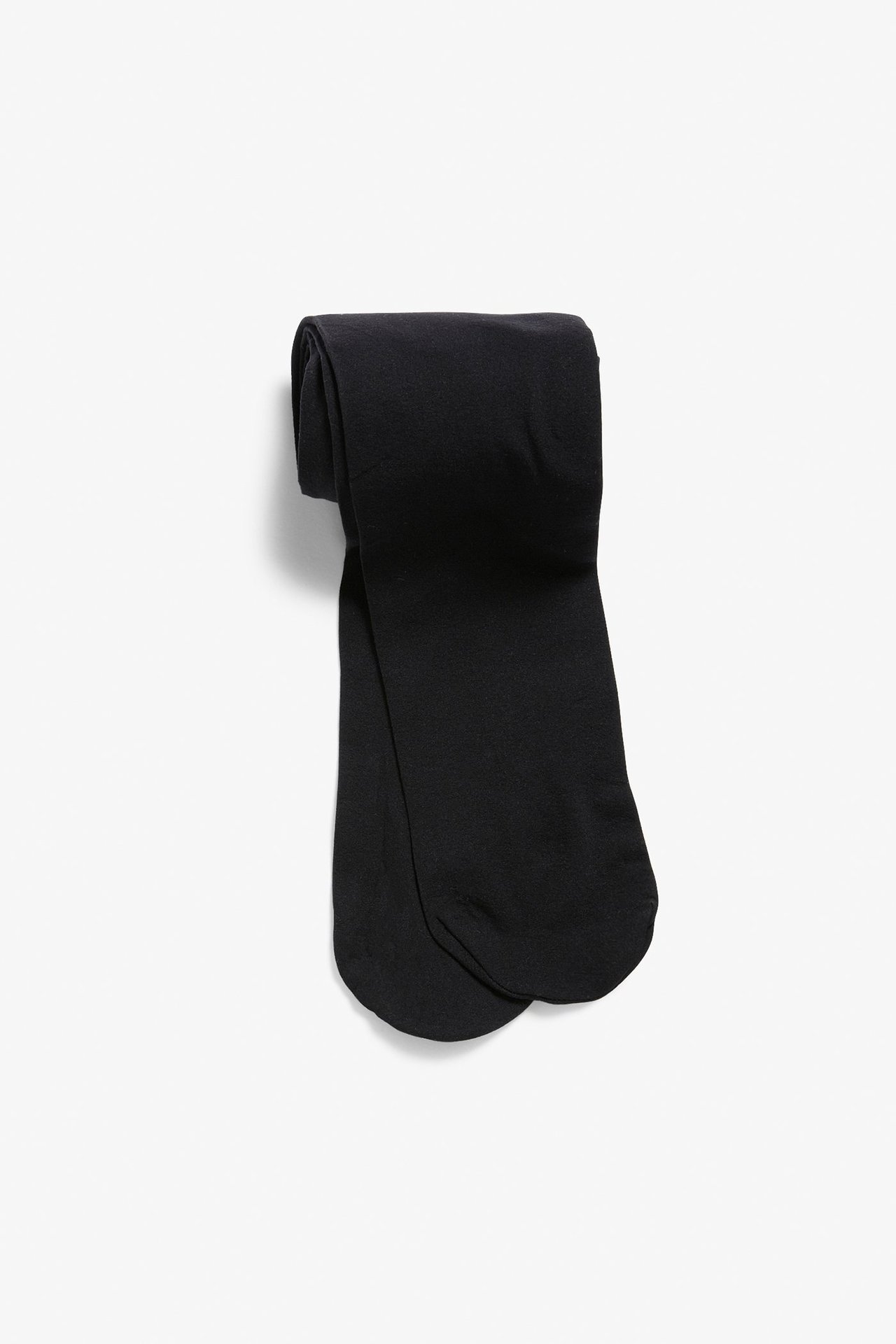 Ylhäältä kuvattu, taitetut mustat 20 denierin sukkahousut.