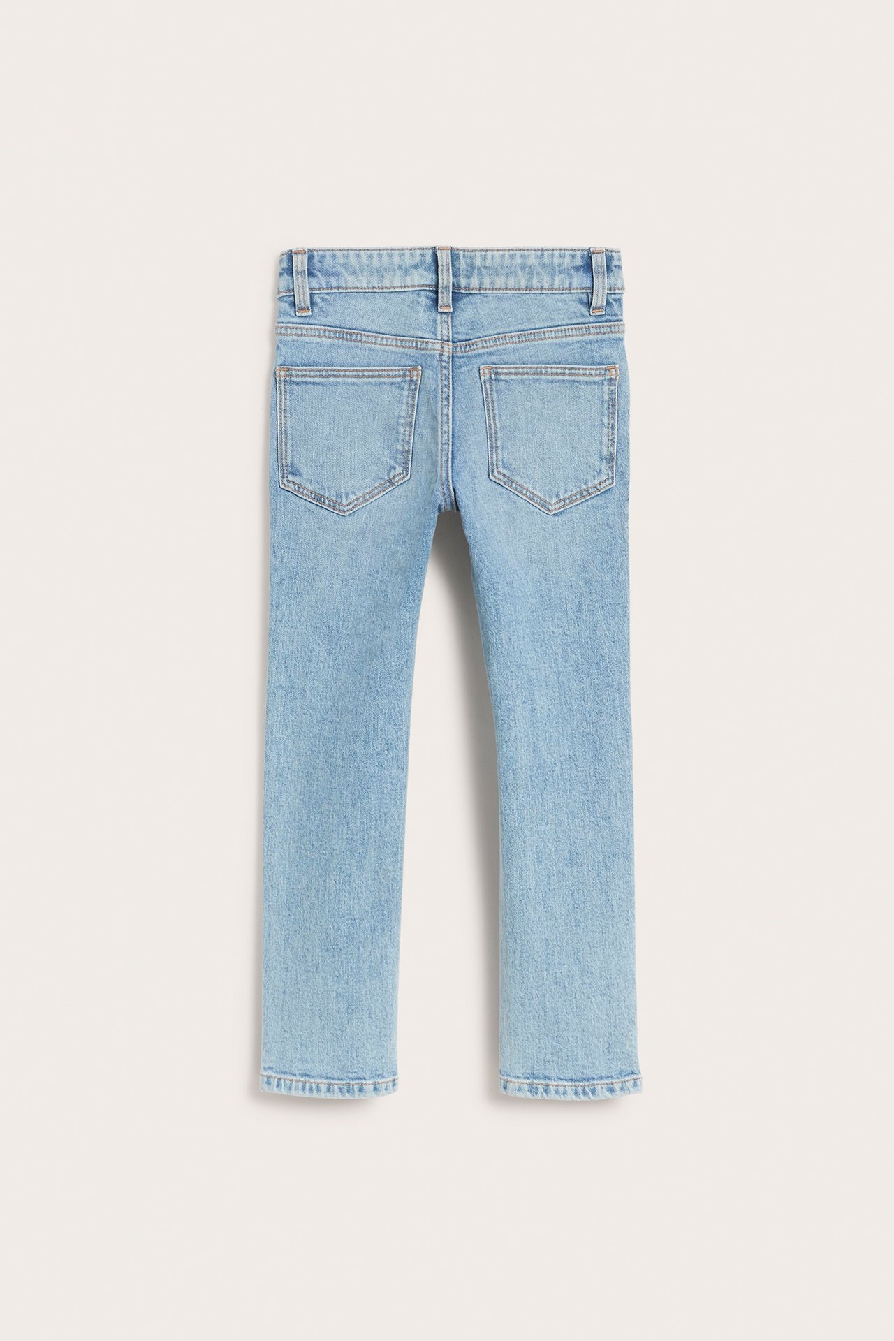 Bakifrån, ljusblå slim-fit barnjeans i denim med två bakfickor och hällor.