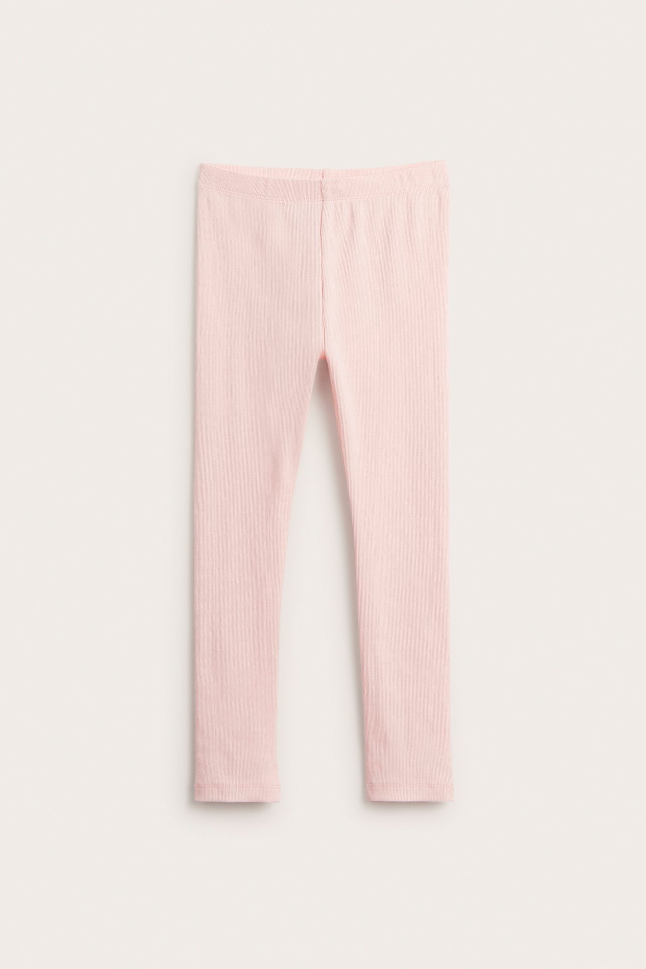 Frontvy av ljusrosa ribbade leggings i bomullsblandning.