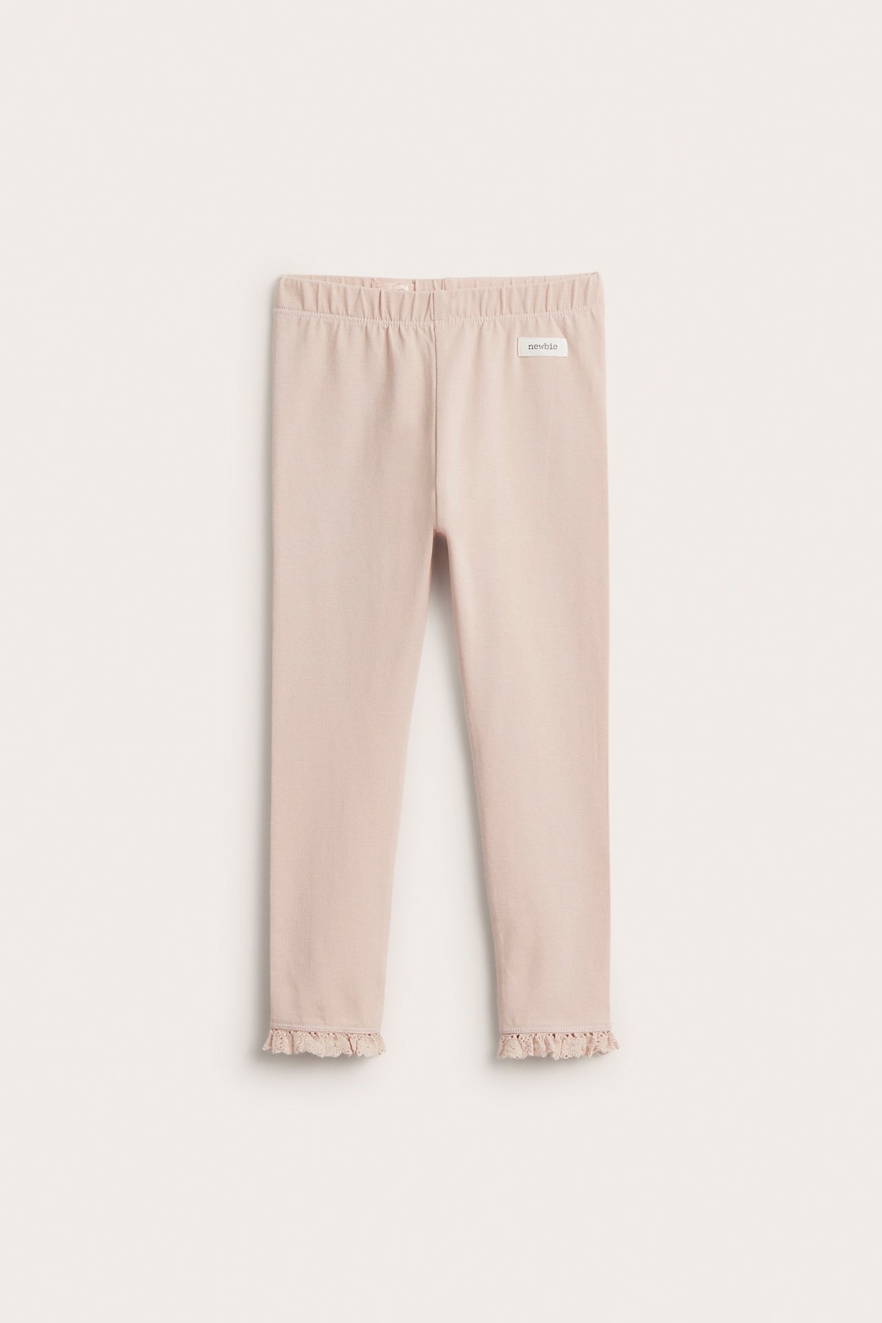 Frontvisning av lyserosa leggings i bomullsblanding med blondevolang ved benåpningene og strikk i midjen.