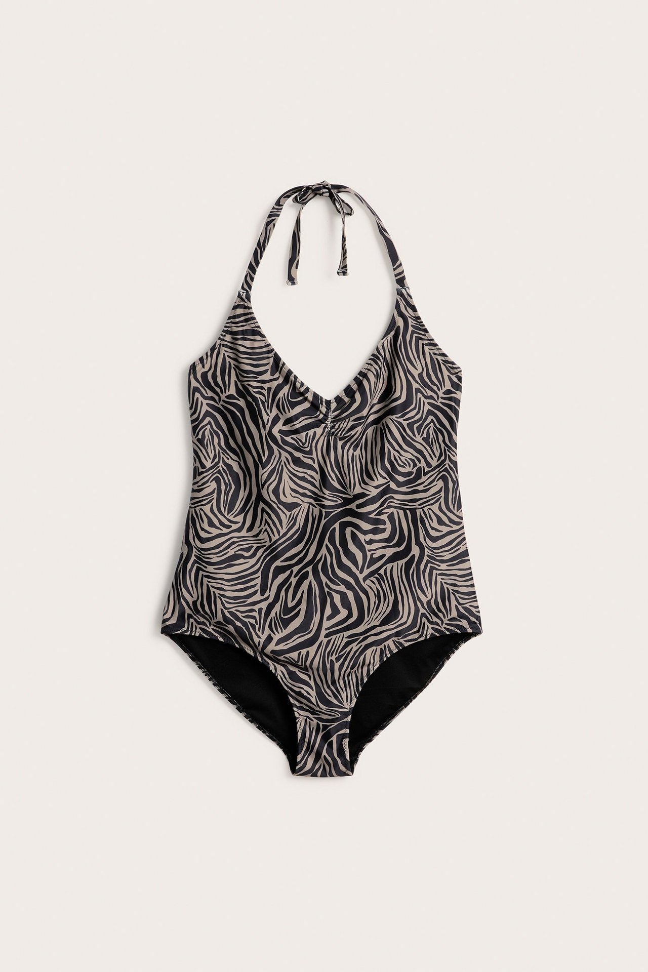 Frontvisning av en mørk beige og svart sebrastripet halterneck badedrakt med knyting.
