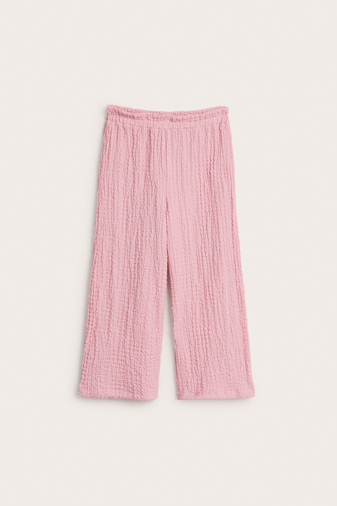 Frontvy av rosa culottebyxor i strukturerad jersey med resår i midjan.