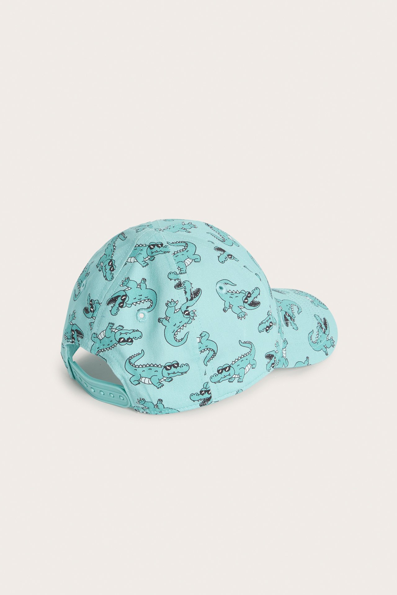 Widok z tyłu turkusowej czapki z daszkiem dla dziecka, z wzorem w krokodyle i zapięciem snapback.