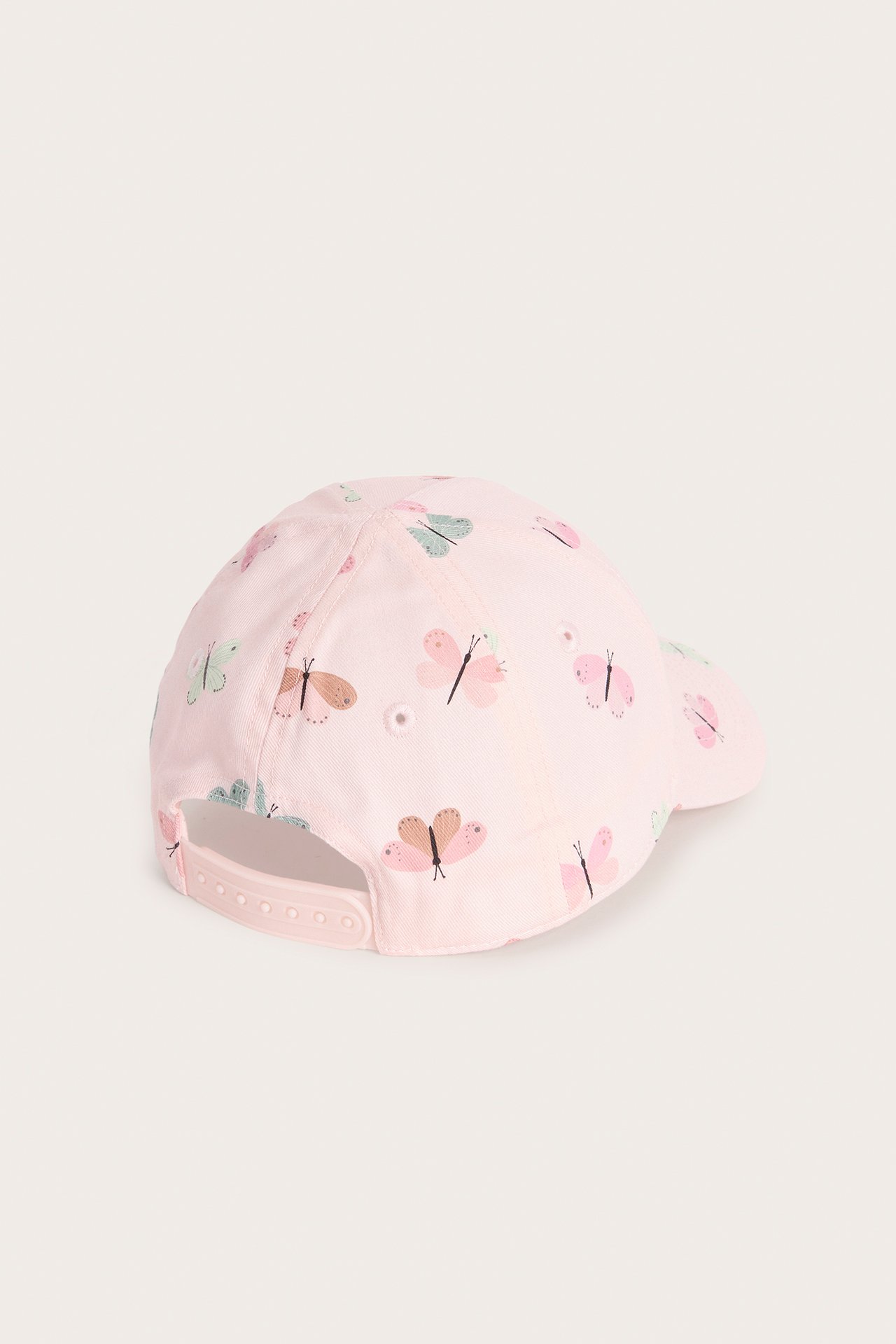 Bakifrån, ljusrosa barnkeps med färgglatt fjärilsmönster och justerbar knäppning baktill.