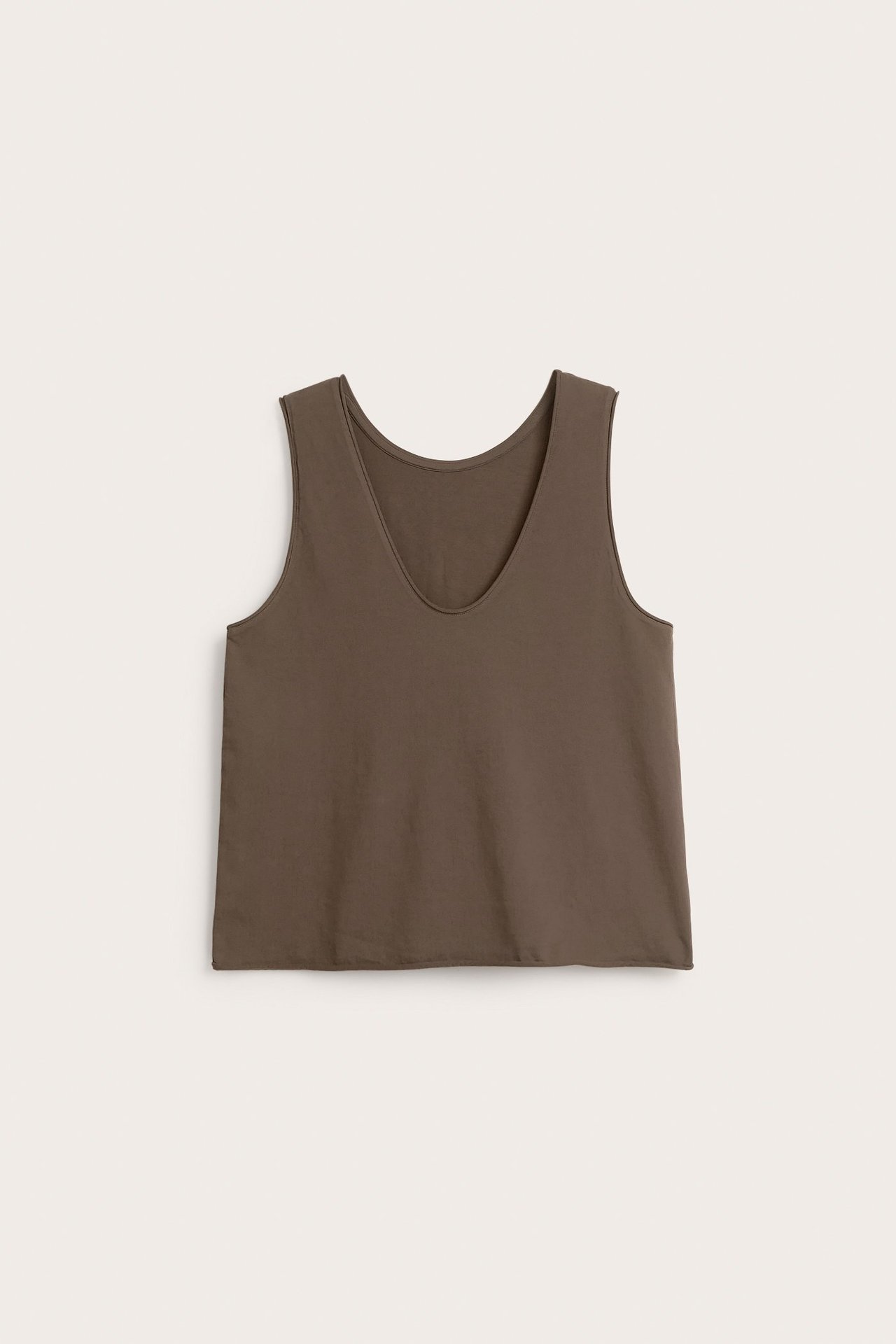 Frontvisning av en brun V-hals singlet i bomullsjersey med rå kanter og lett vasket look.
