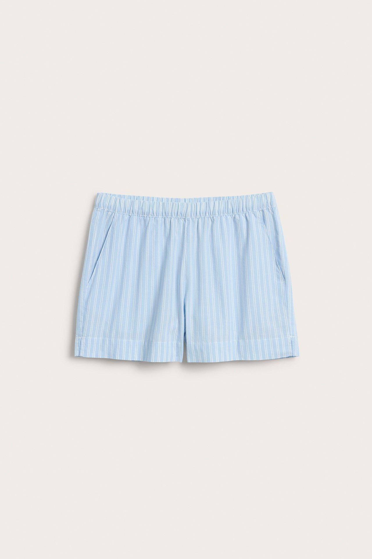 Framsida av ljusblårandiga vävda pyjamasshorts i bomull med resår i midjan och sidfickor.