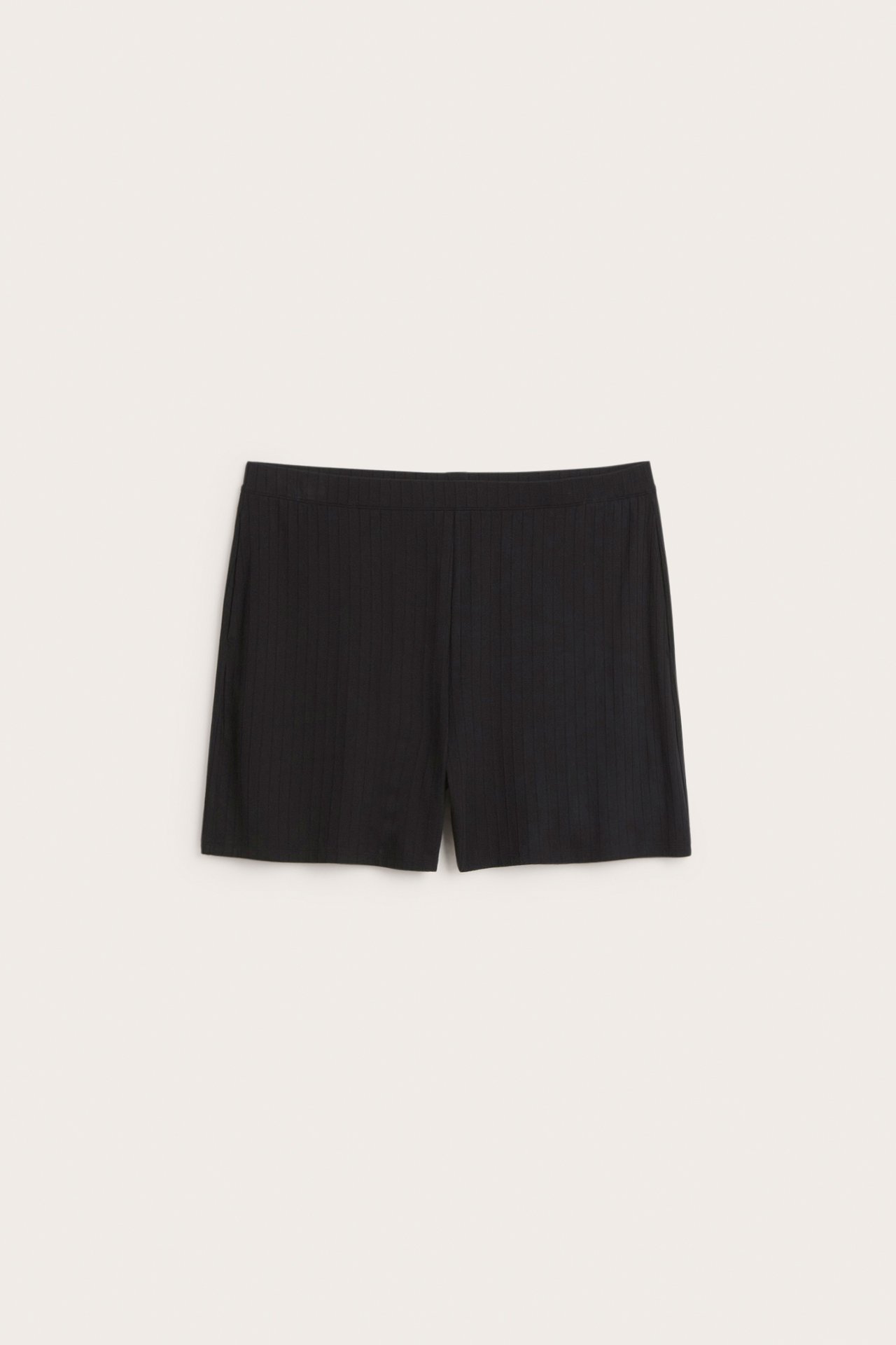 Frontvy av svarta ribbade jersey shorts med resår i midjan.