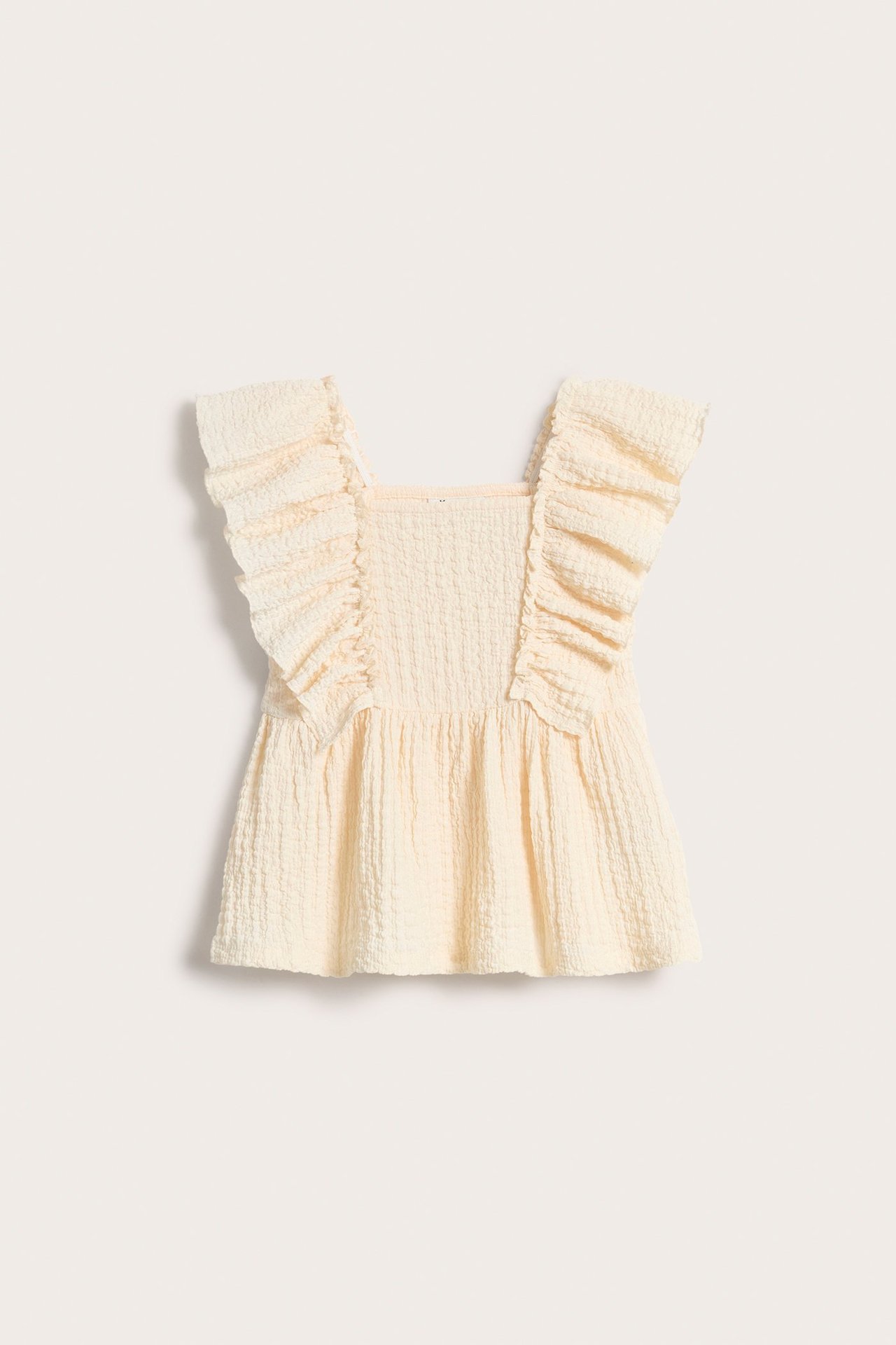 Widok z przodu: Ecru bluzka z marszczonego dżerseju z dużymi falbanami na ramionach.