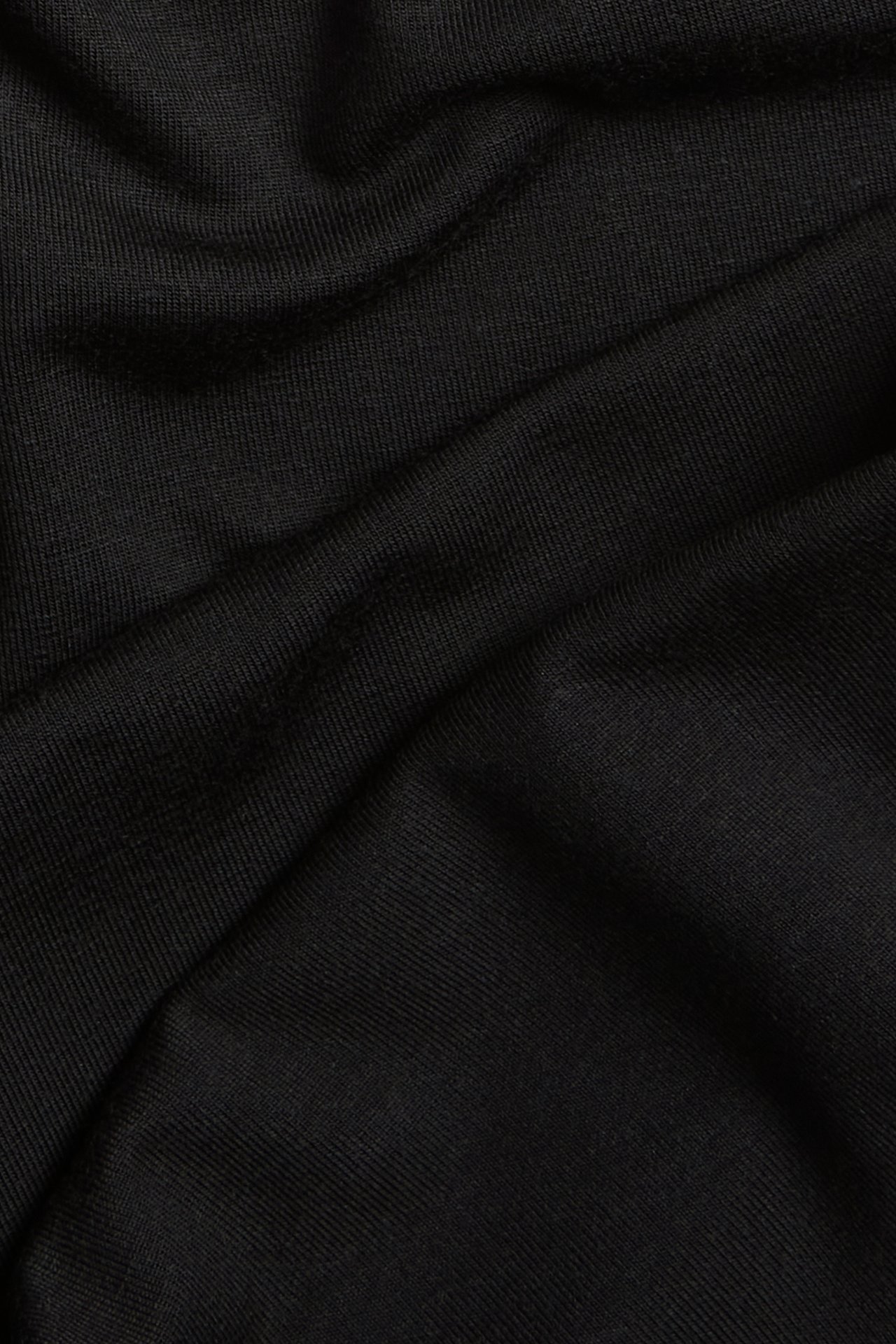 Lähikuva mustasta viskoosisekoitekankaasta, pehmeästi laskostettuna, pyöräilyshortseille.