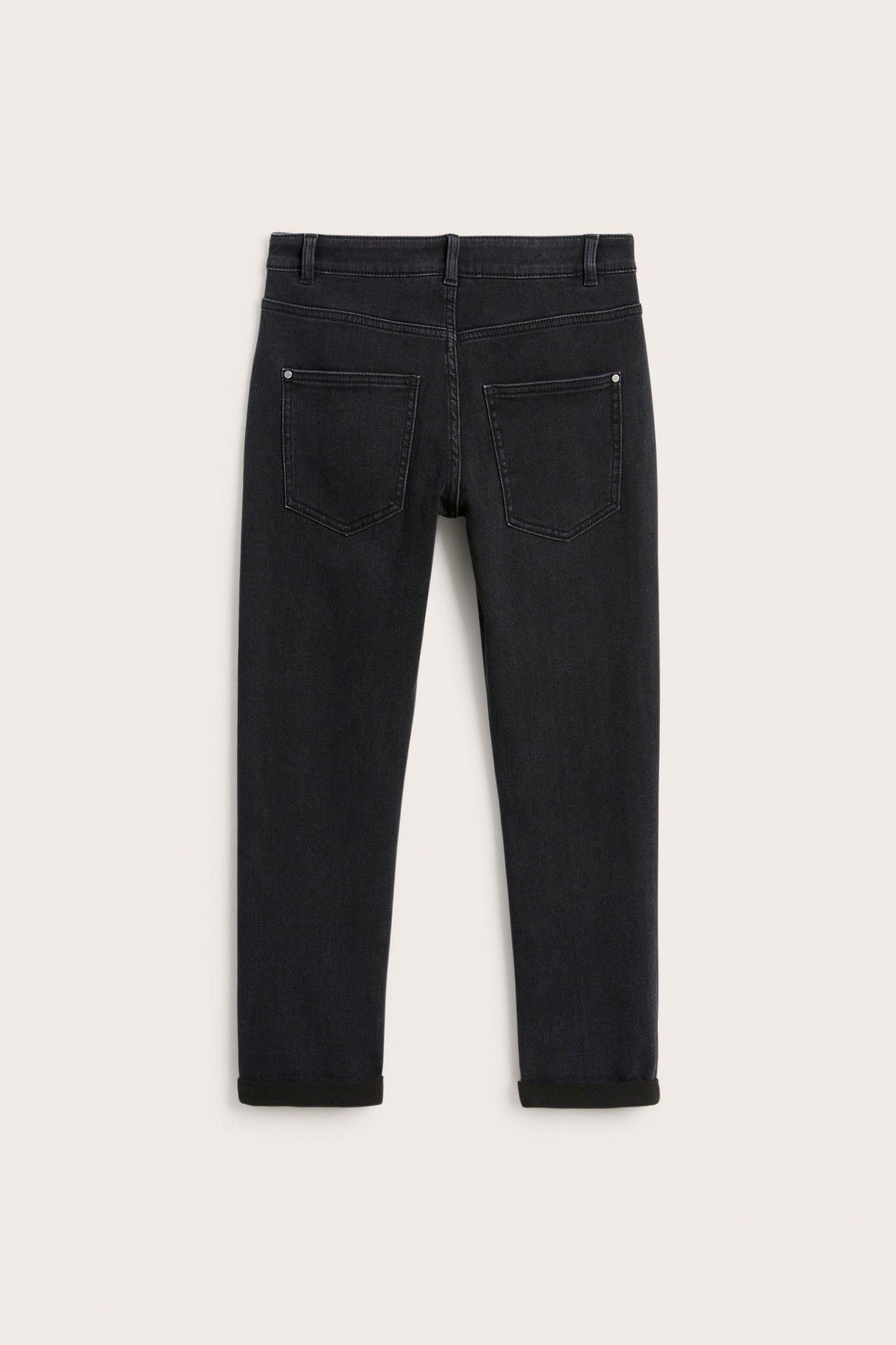 Bakfra svarte relaxed jogger denim jeans med oppbrettede ben og to baklommer.