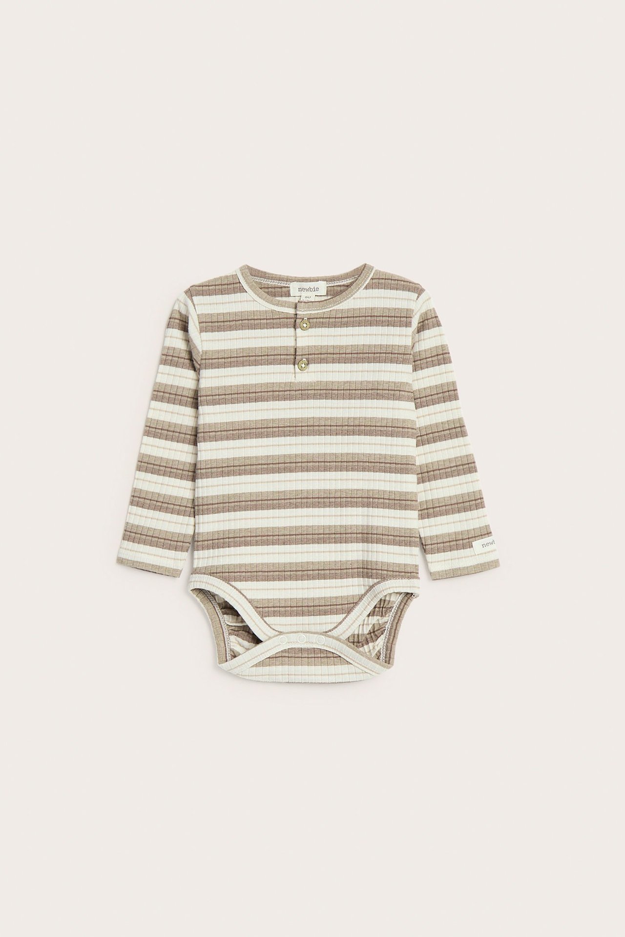 Edestä: vauvan ribattu pitkähihainen body, beige-vaaleat raidat, edessä napit, haaran nepparit.