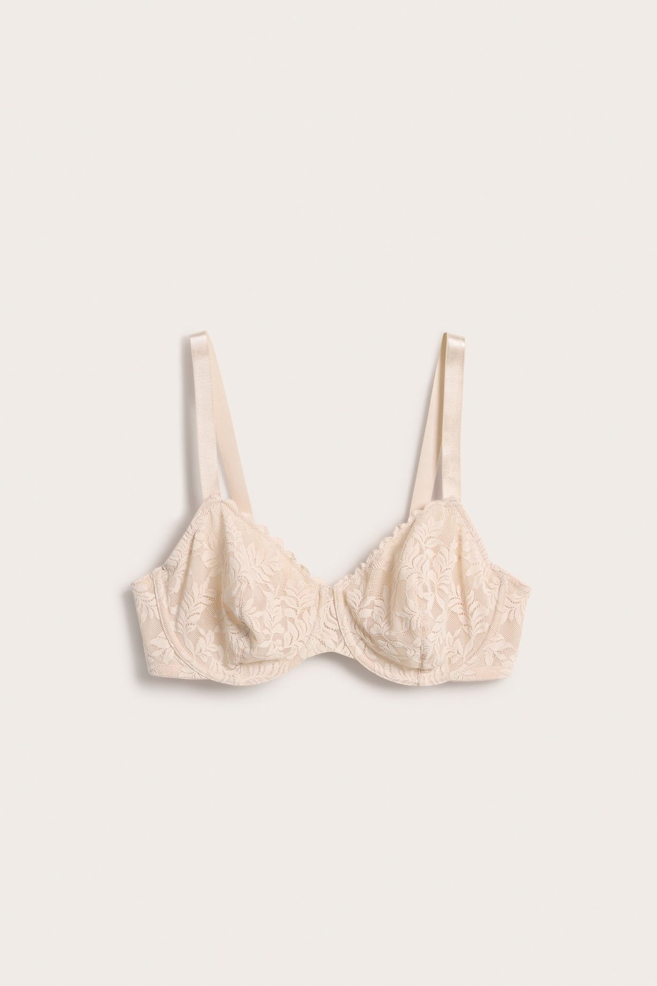 Forfra, en lys rosa stretch blonde-BH med bøyle, uvattert.