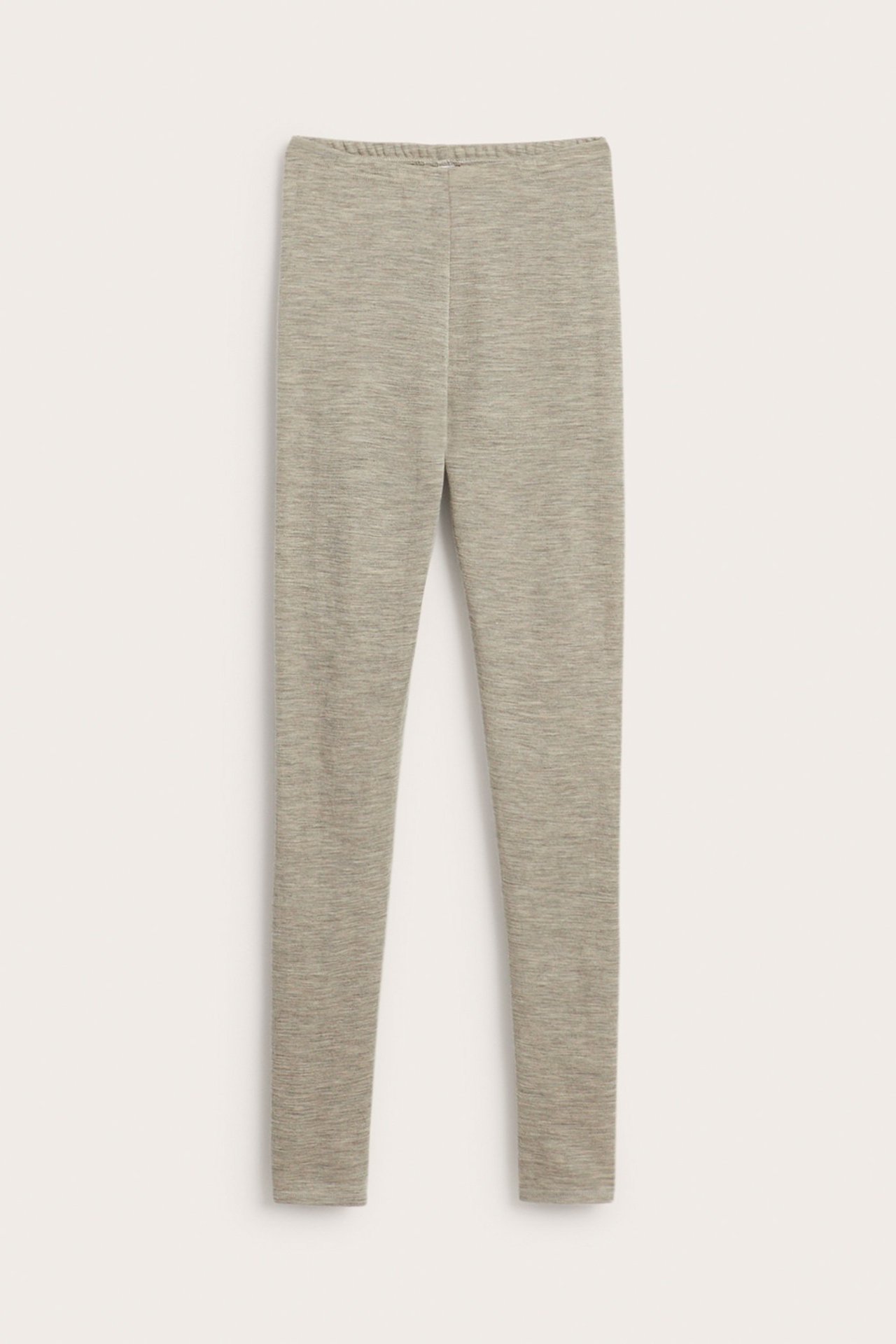 Framifrån: beigemelange merinoullsleggings med resår i midjan.