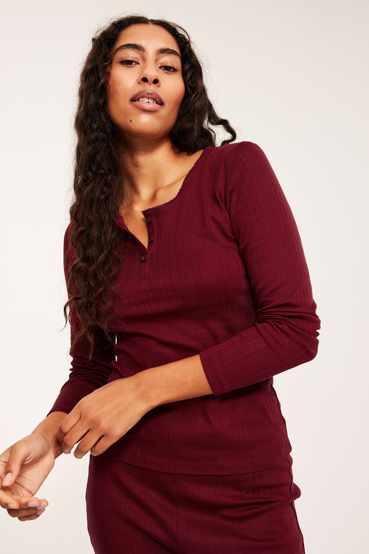 Pitkähihainen tummanpunainen pyjamapaita ribbineulosta, naiselle tarkoitettu.