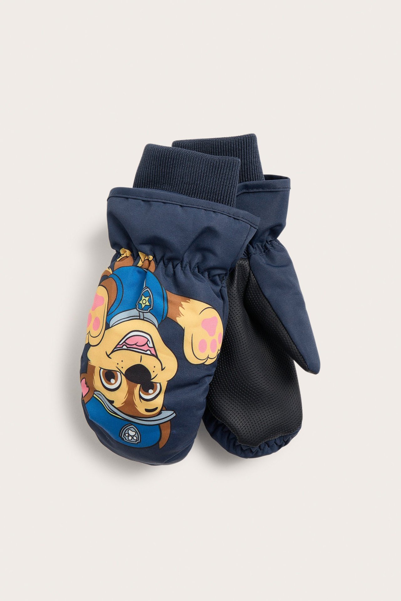 Edestä: tummansiniset lasten kudotut rukkaset, joissa Ryhmä Hau Chase -kuvio ja musta PU-pito.