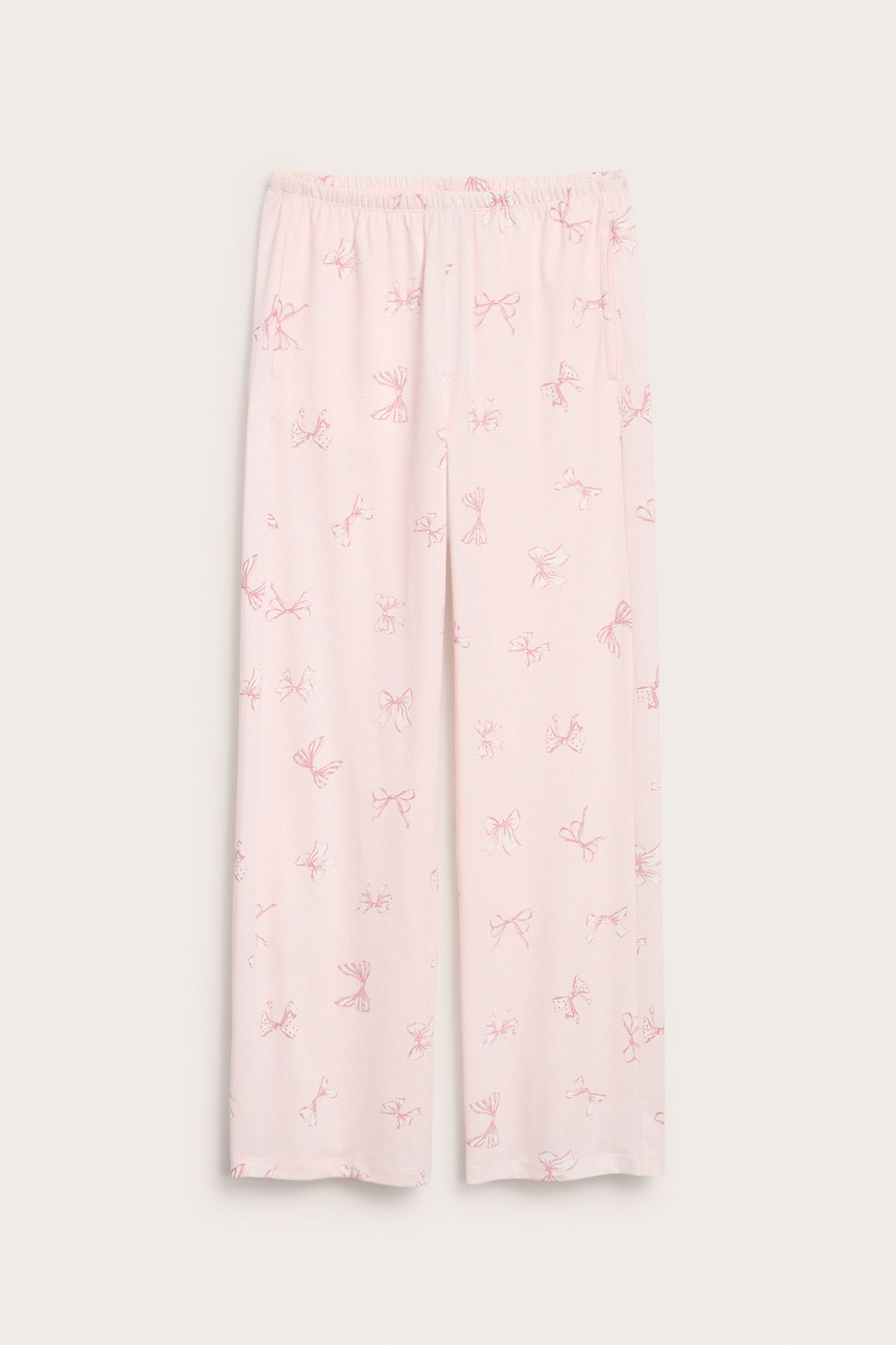 Frontbilde av lys rosa pyjamasbukse i bomullsjersey med rosarosemønster og elastisk midje.