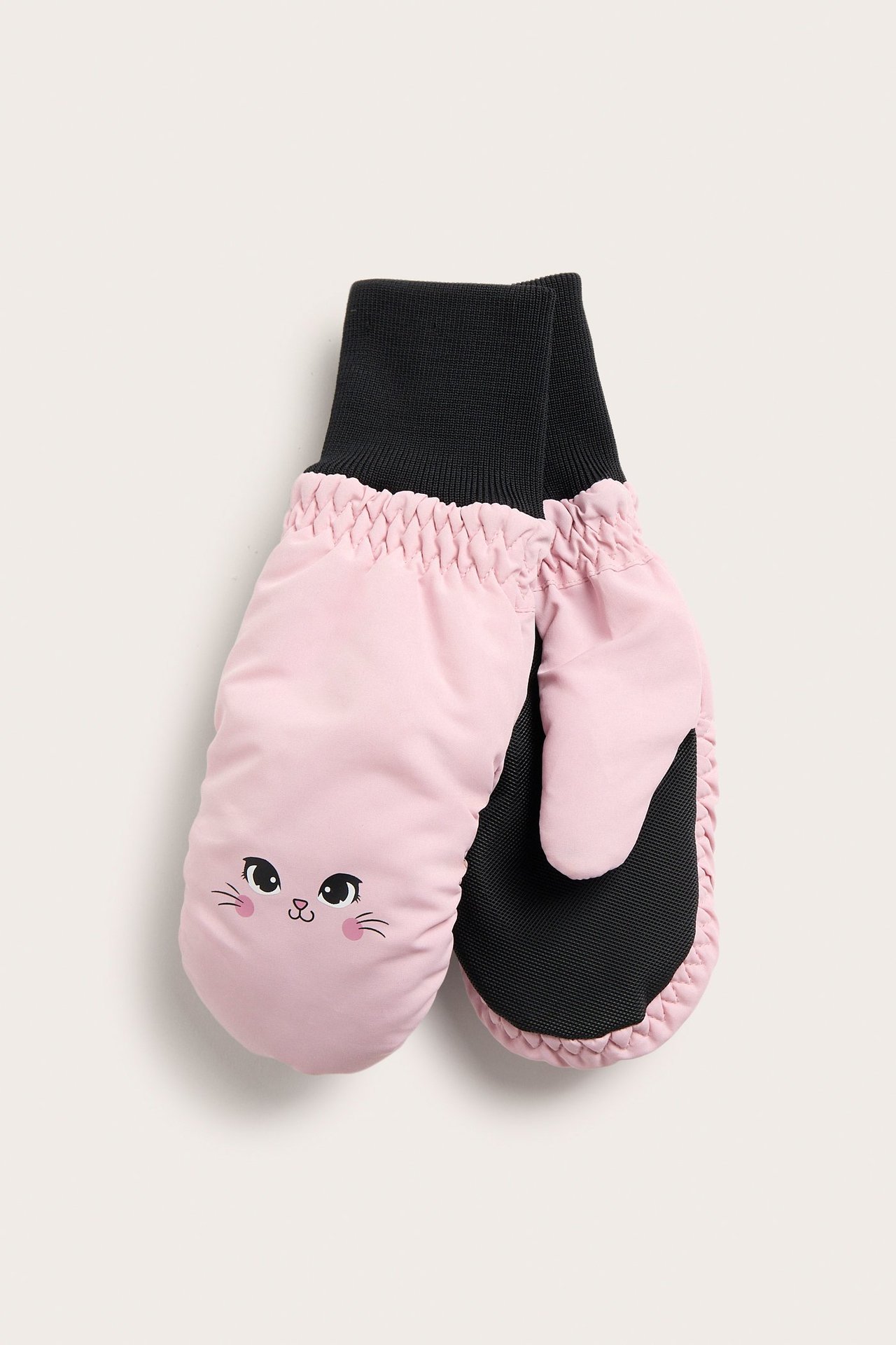Widok z przodu: jasnoróżowe rękawiczki z nadrukiem kociej twarzy i czarnymi ściągaczami.