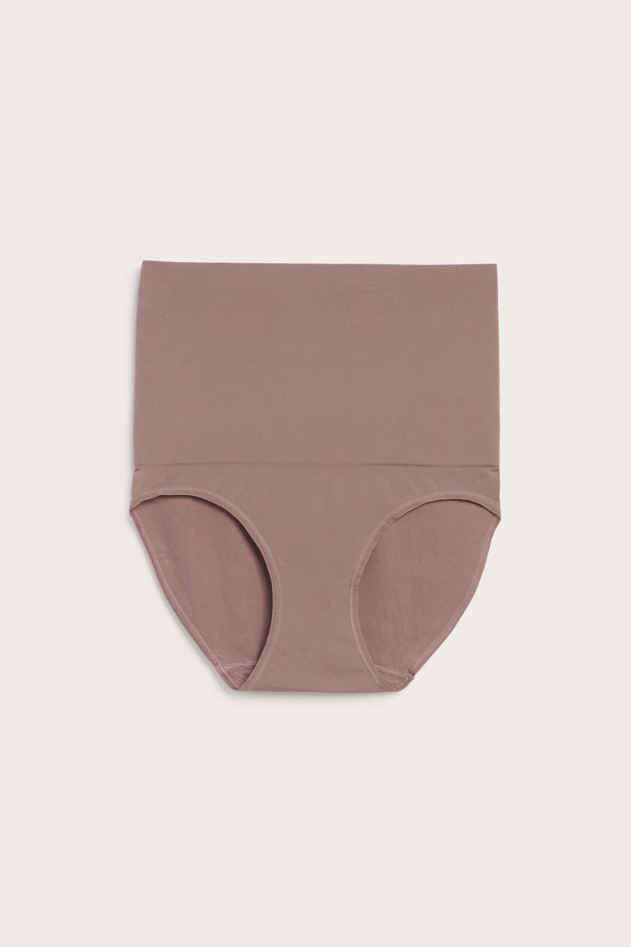 Frontvisning av en mørk rosa høy shapingtruse i glatt, ensfarget polyamid-elastanblanding.