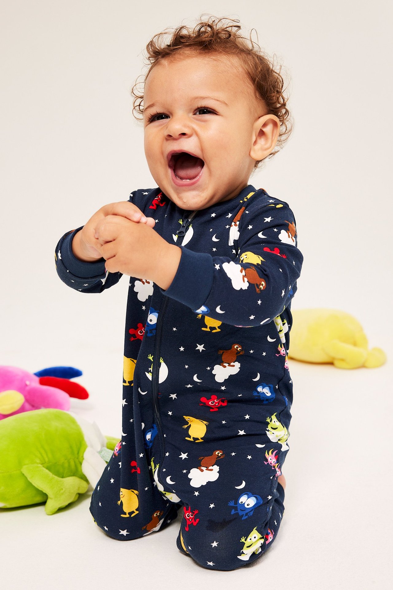 Baby i mörkblå overall med Babblarna-motiv, dragkedja fram, mönstrad.