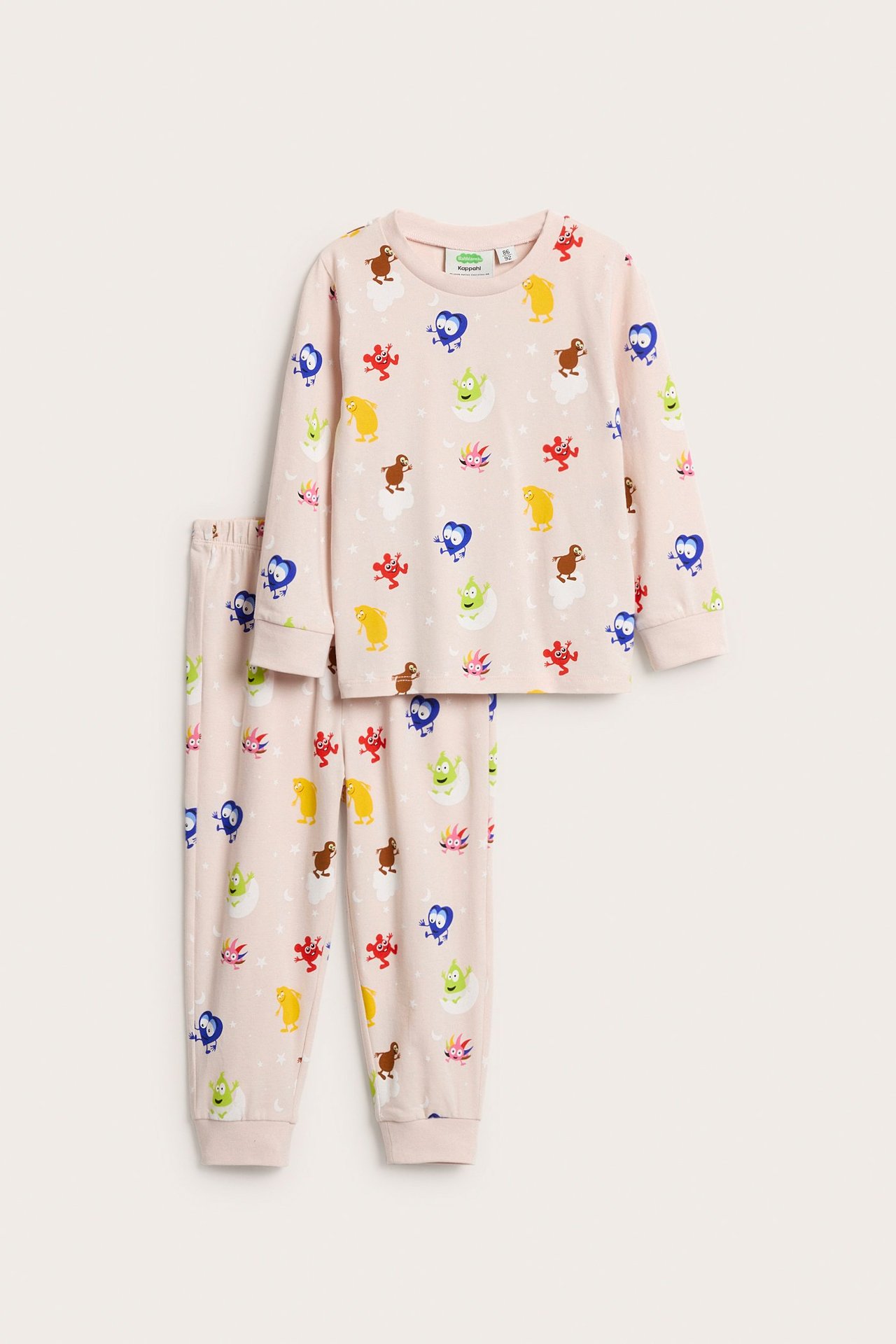 Framifrån: Rosa pyjamas i bomull för barn med färgglatt Babblarna-mönster, långärmad tröja och muddbyxor.