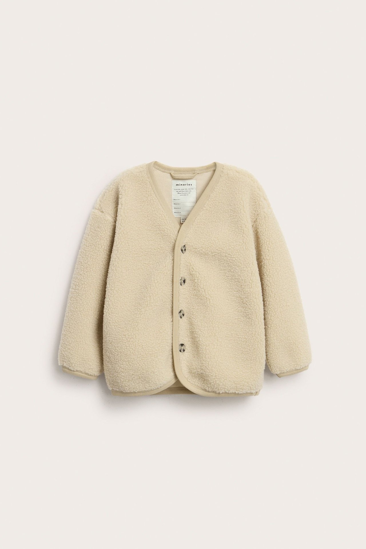 Beige, yksivärinen pilé-neuletakki lapsille, etupuoli, pitkähiha, napit.