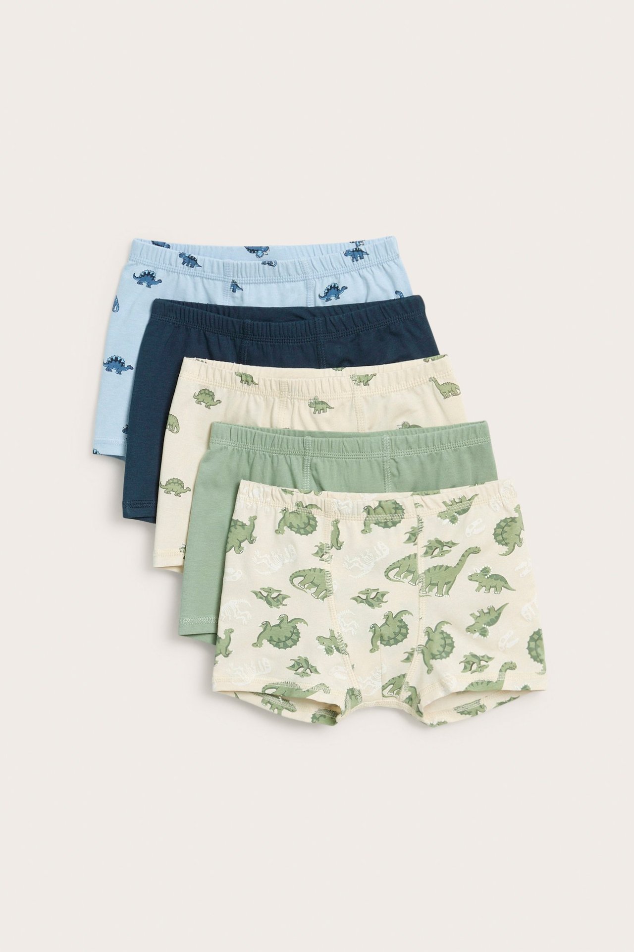 Edestä, viisi lasten bokseria: kolme dinosauruskuvioitua, kaksi yksiväristä, beigenä, sinisenä ja vihreänä.