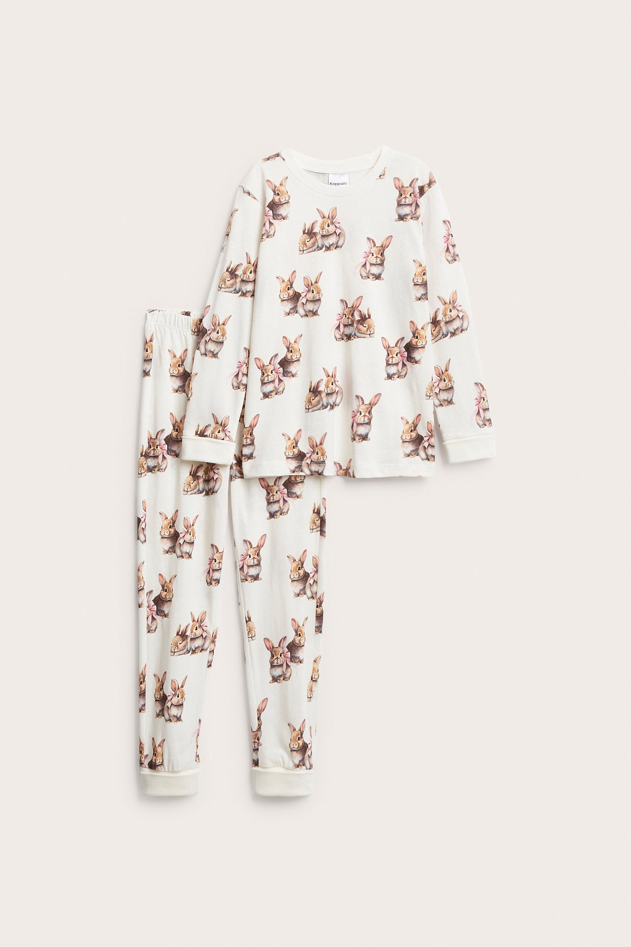 Framsida av en benvit pyjamas i bomull för barn, med långa ärmar och kaninmönster.