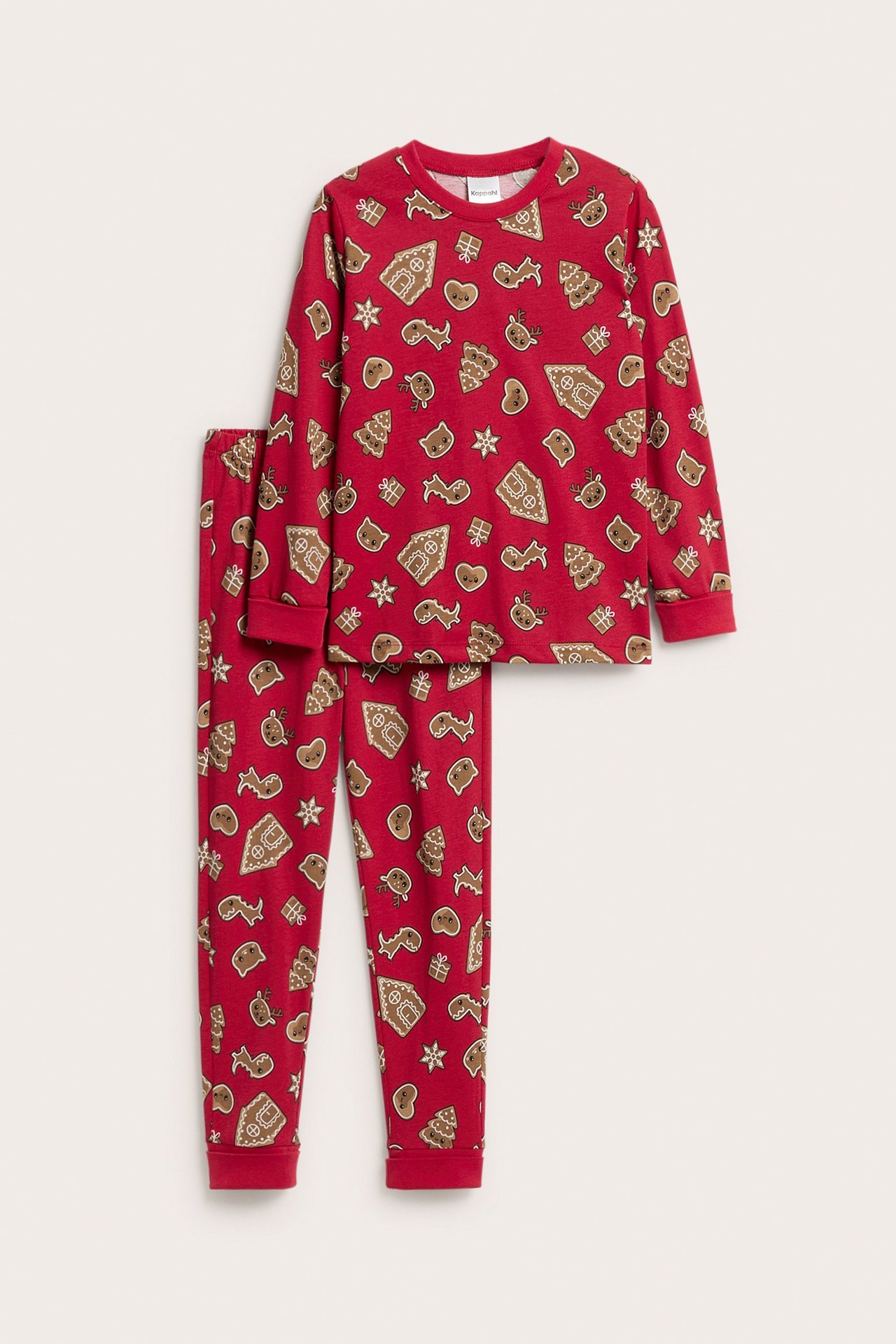 Framifrån: Rött pyjamasset i bomull för barn med pepparkaksmönster.