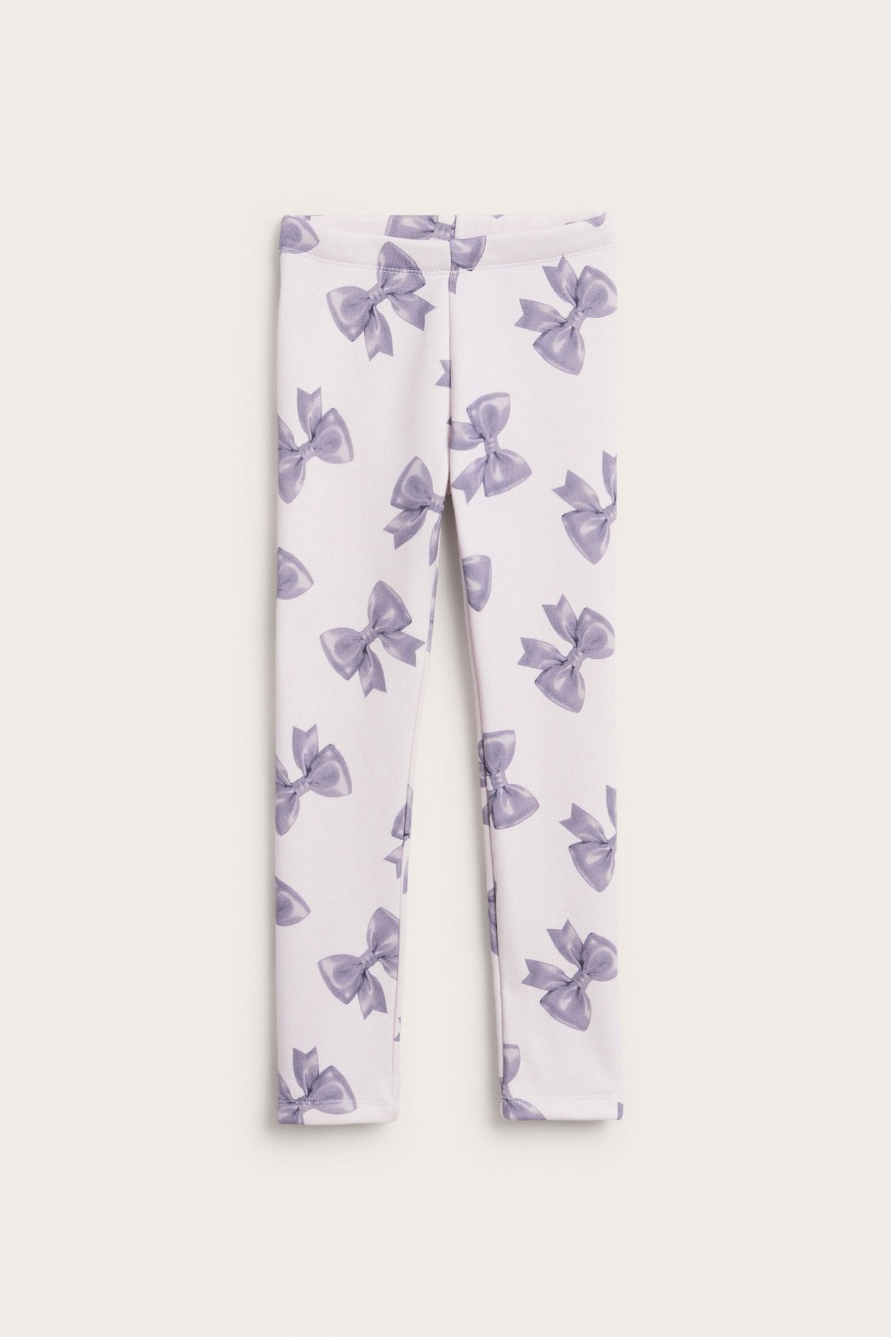 Lämpimät lasten leggingsit vaaleassa lila- värissä, pehmeä sisäpuoli, kuvioina rusetti.