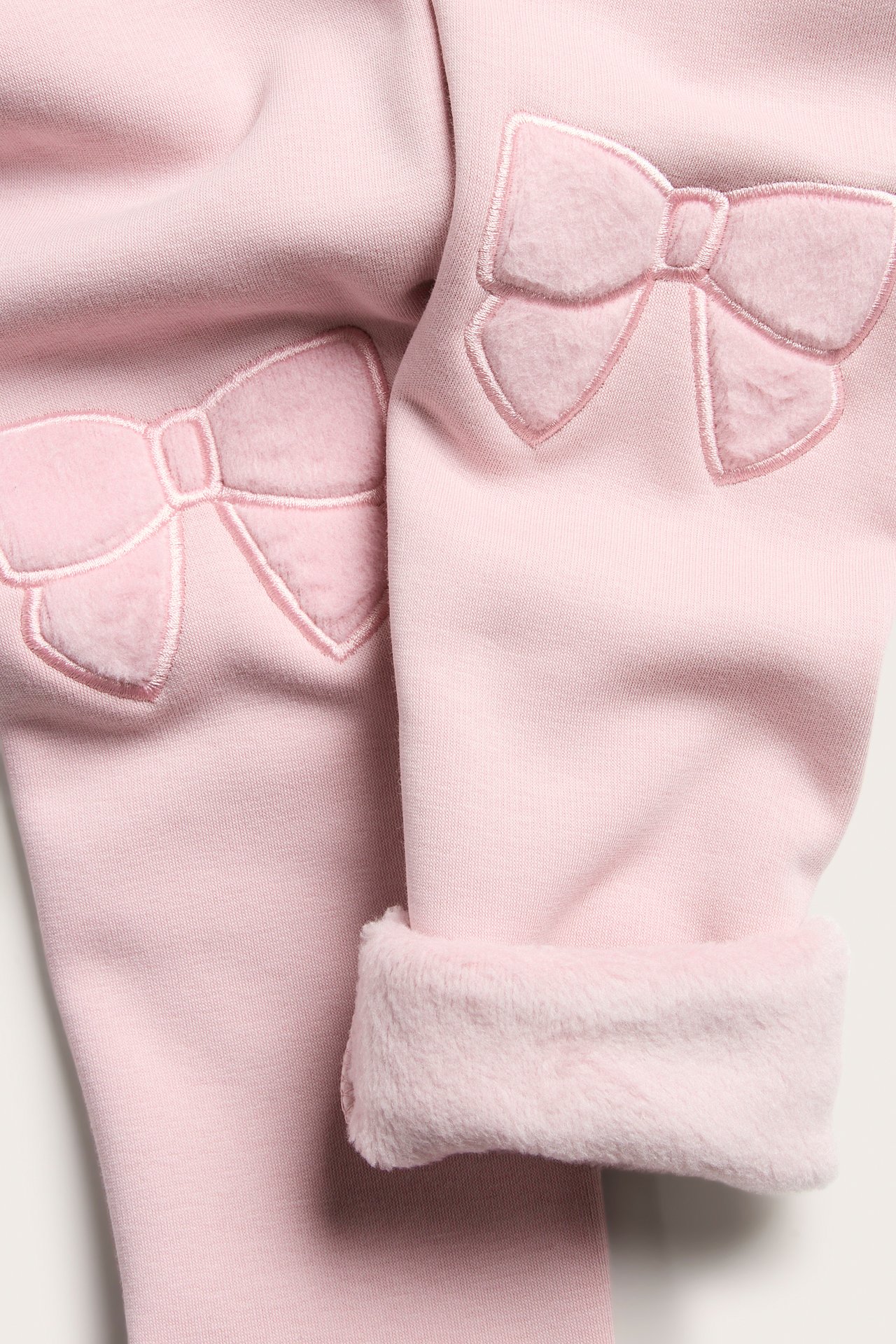Vaaleanpunaiset lasten leggingsit, brodyroitu polyforme, pehmeä sisäpuoli.
