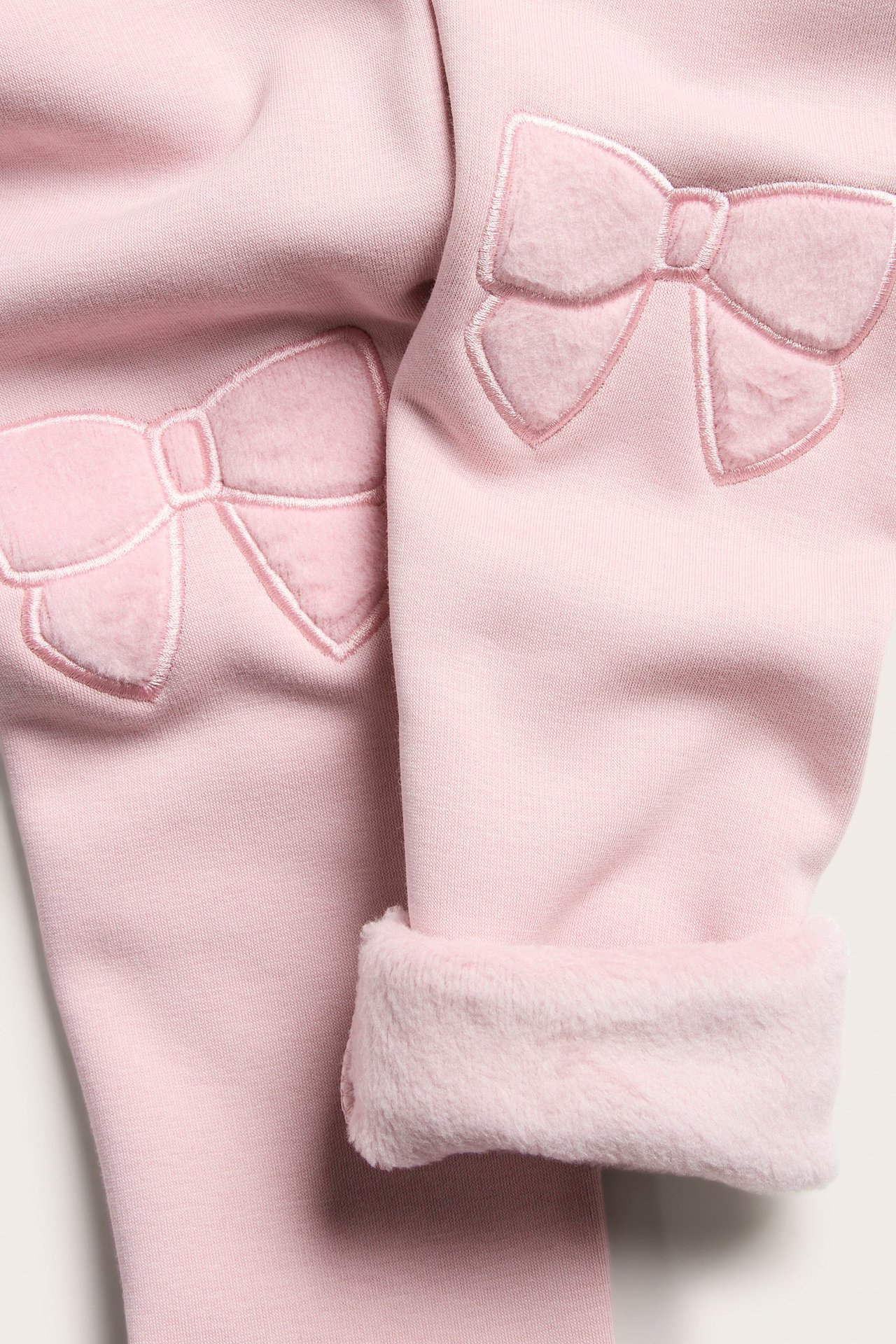 Vaaleanpunaiset lasten leggingsit, brodyroitu polyforme, pehmeä sisäpuoli.