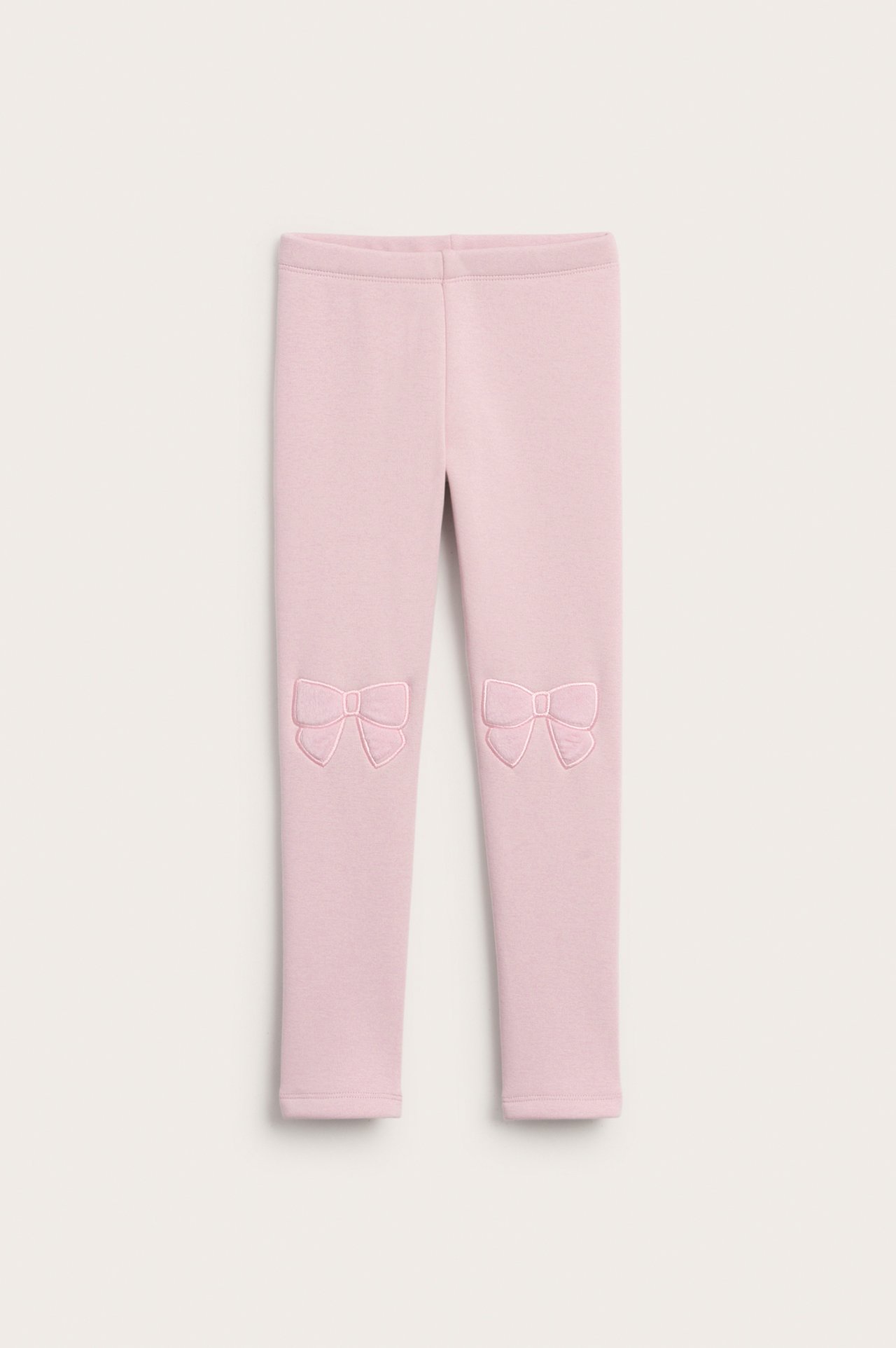 Vaaleanpunaiset lämpöleggingsit pehmeällä sisuksella ja kirjotuilla nauhoilla polvissa, lapsi.