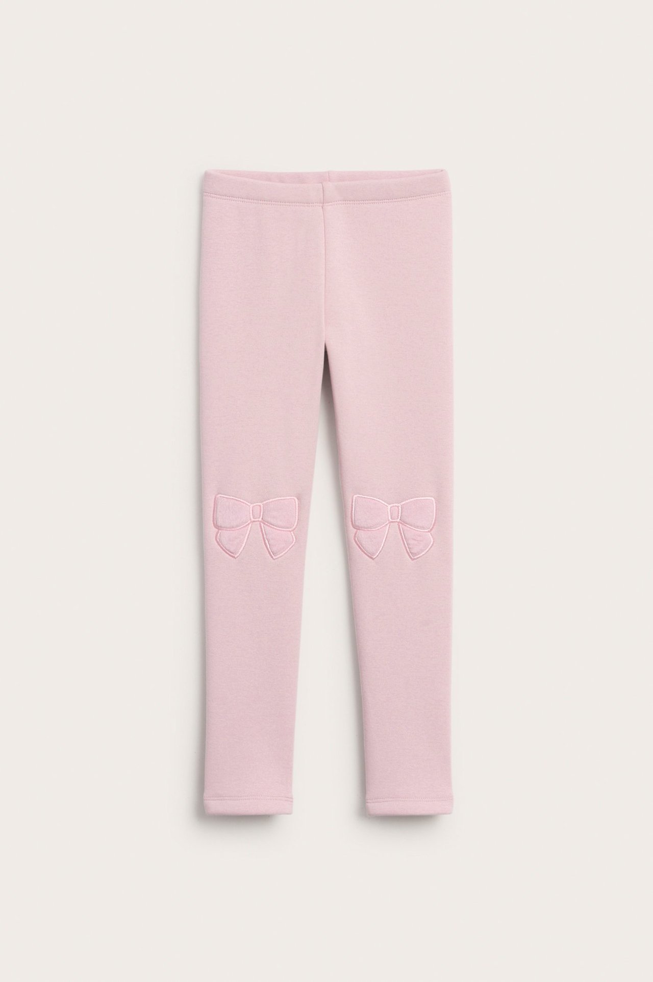 Vaaleanpunaiset lämpöleggingsit pehmeällä sisuksella ja kirjotuilla nauhoilla polvissa, lapsi.